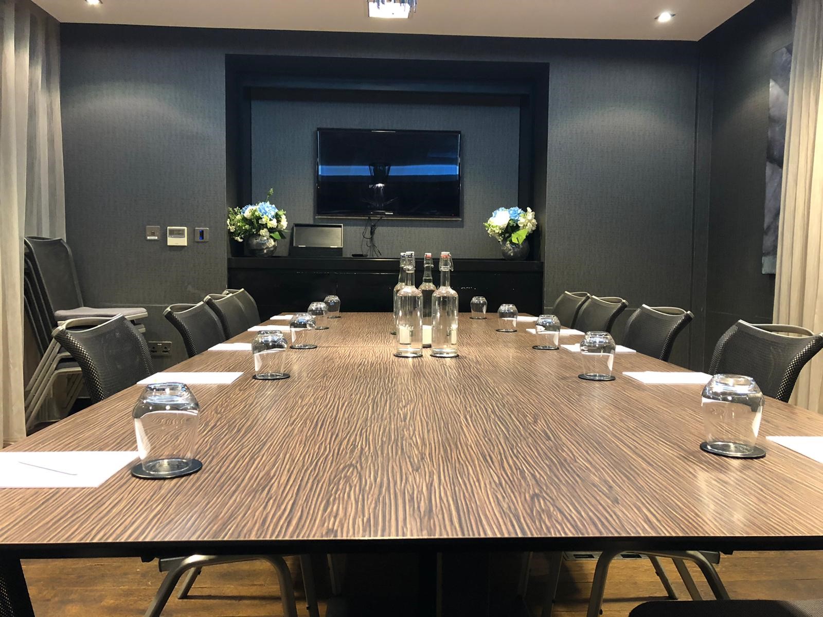 Boardroom at Holiday Inn Southend, modern table set for professional meetings and presentations.