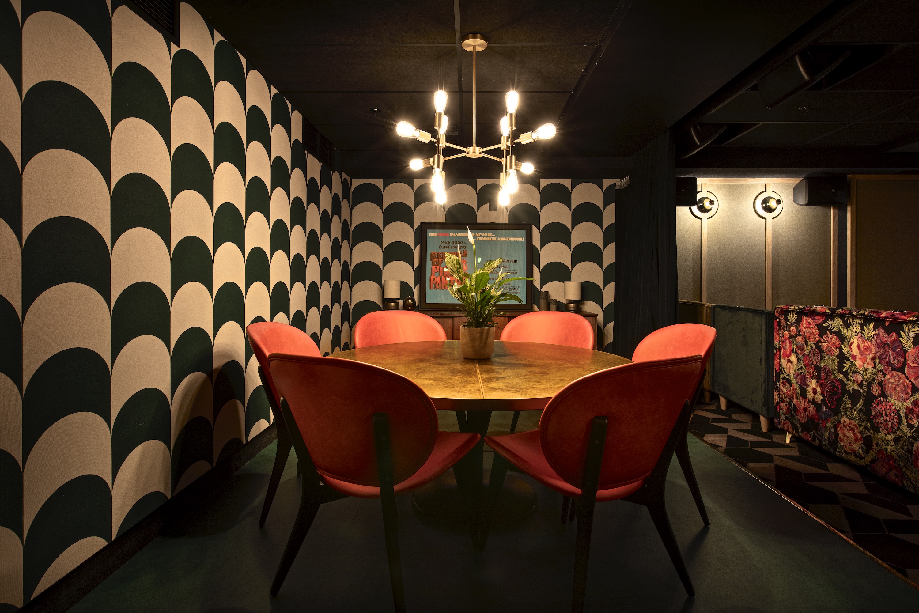 "Stylish round table meeting space with red chairs at Everyman Broadgate for events"