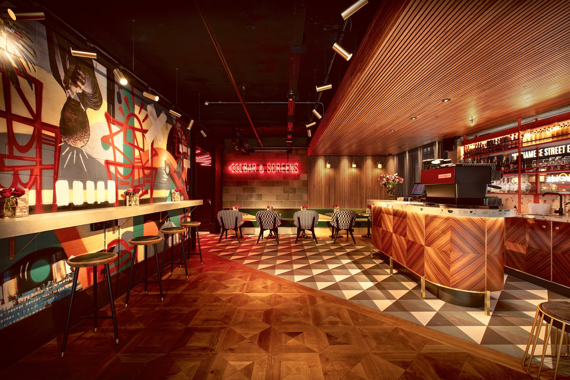 Vibrant event space with modern bar, ideal for networking and cocktail receptions.