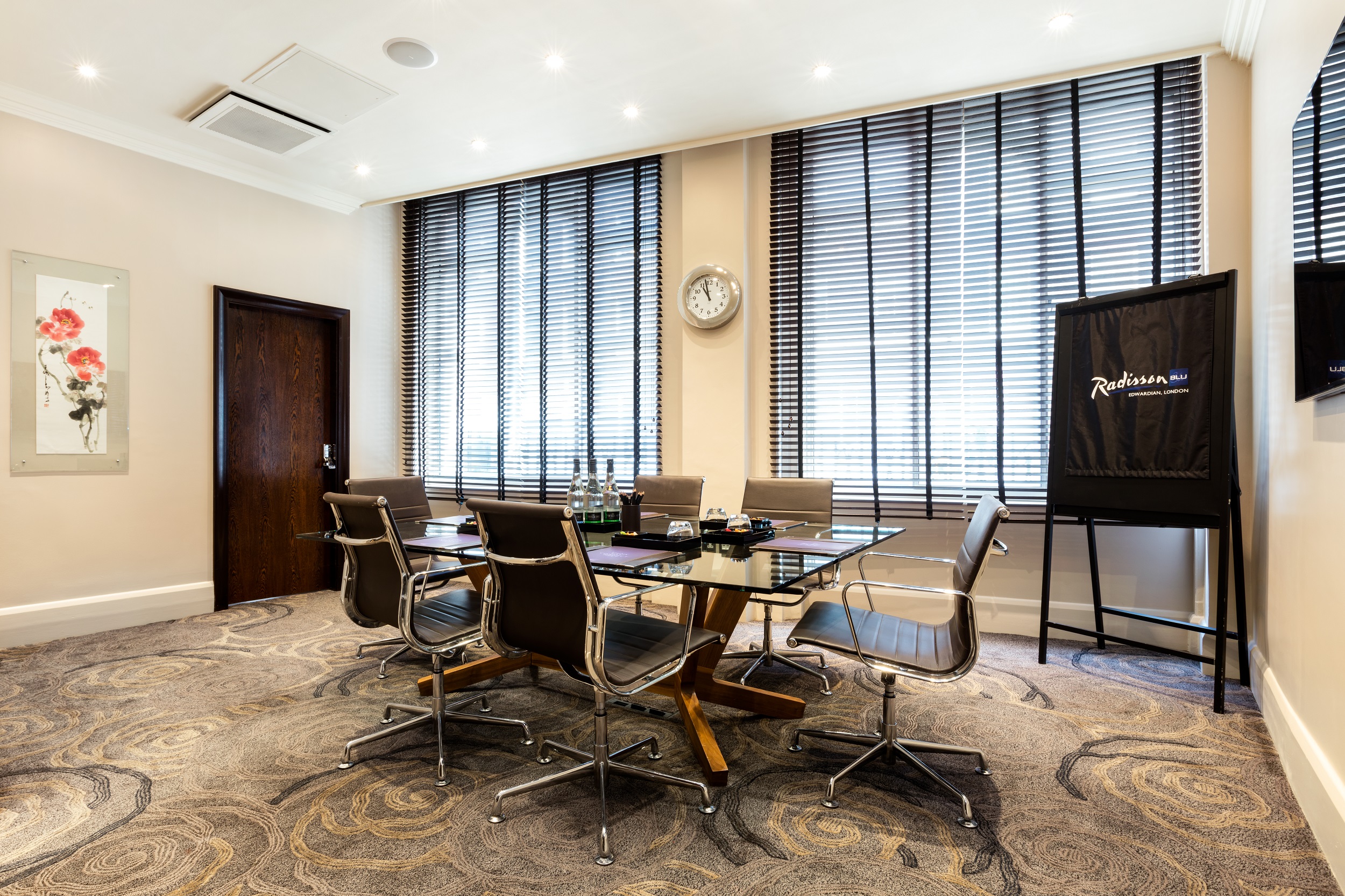 Private Room 8 at Radisson Blu London: modern meeting space with glass table and natural light.