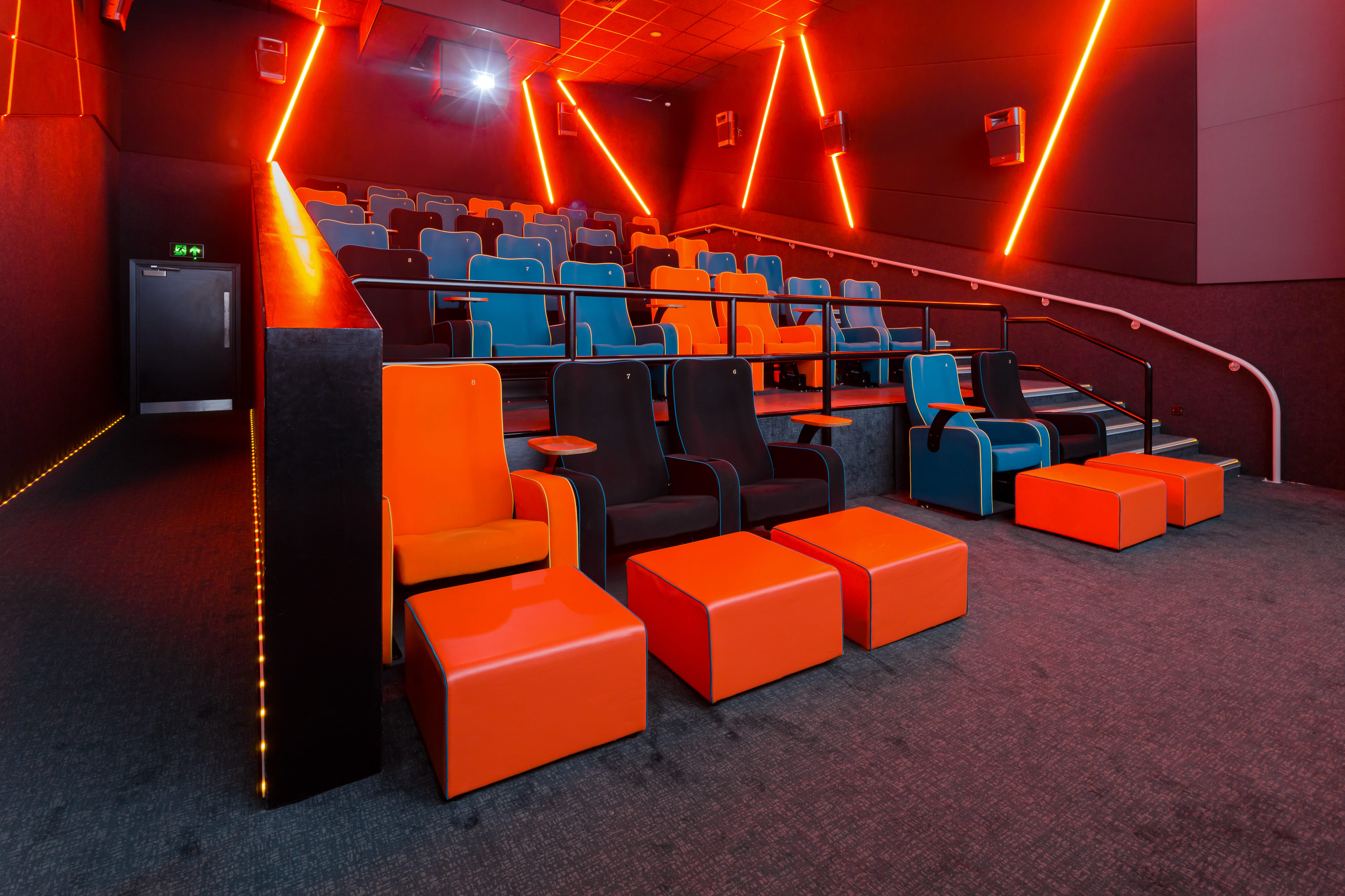 Modern auditorium with vibrant orange and blue seating for events in The Light Cinema Stockport.