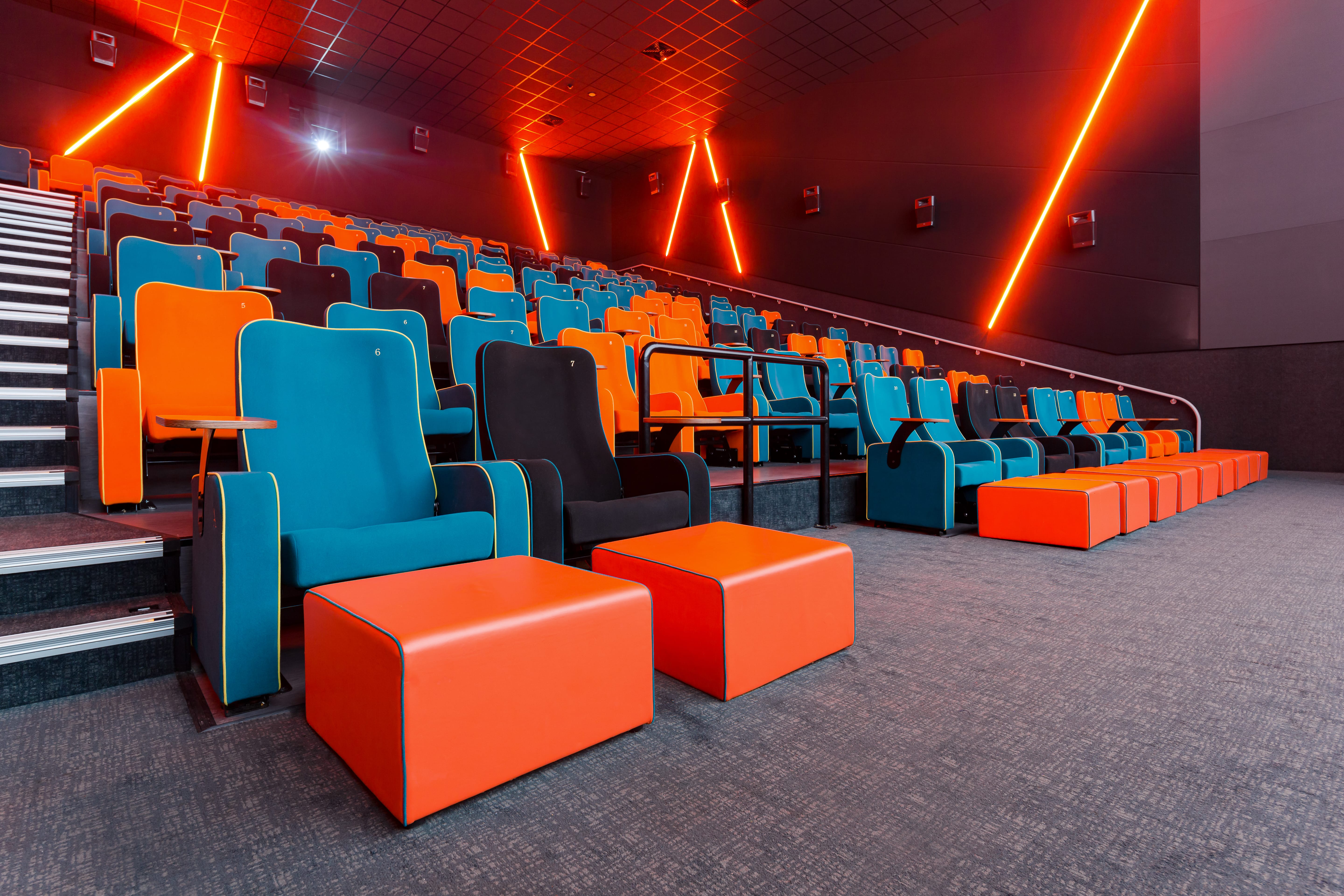 Modern auditorium with vibrant seating, ideal for conferences and film screenings.