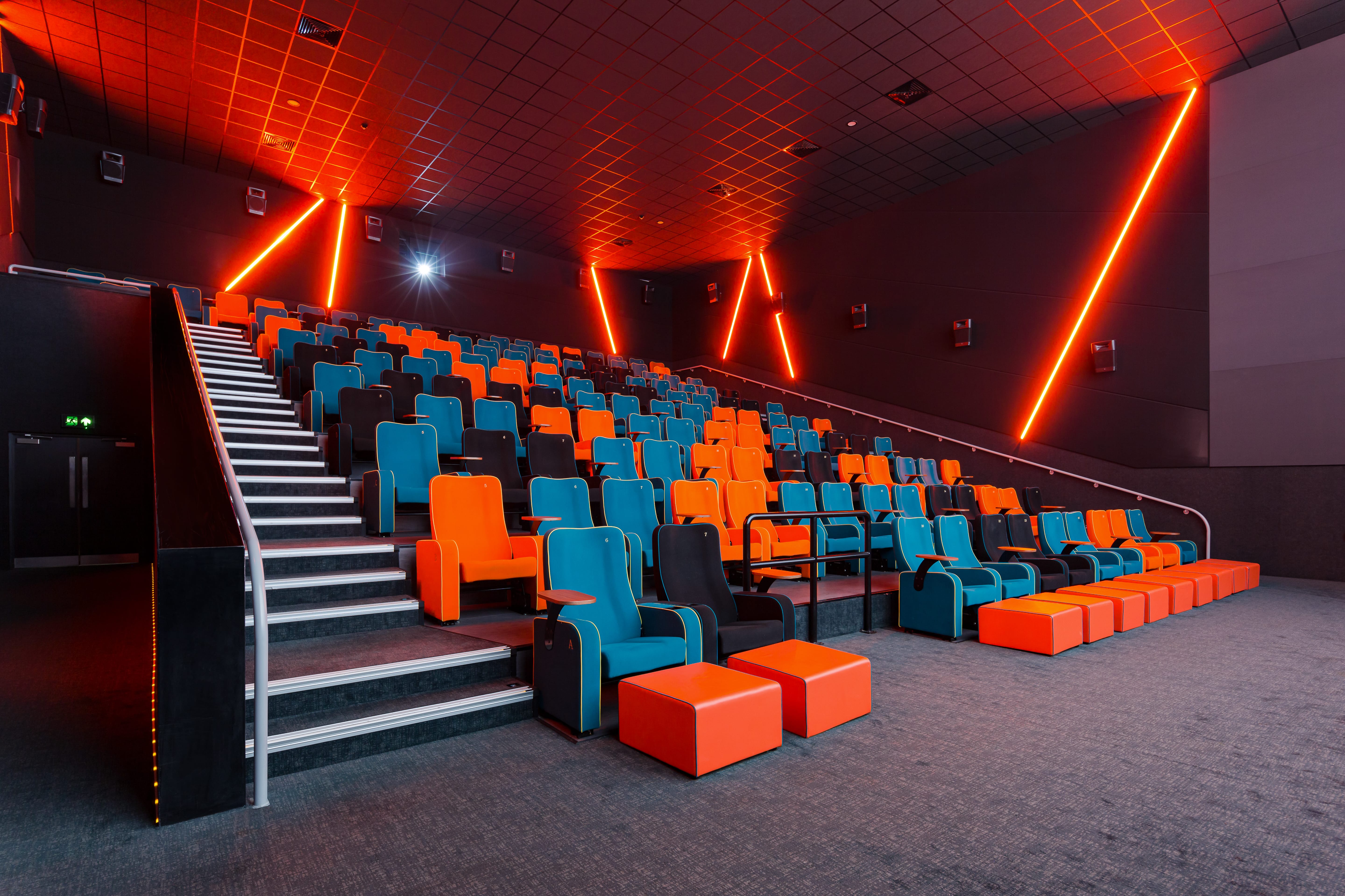 Modern auditorium with vibrant seating for film screenings and corporate events.