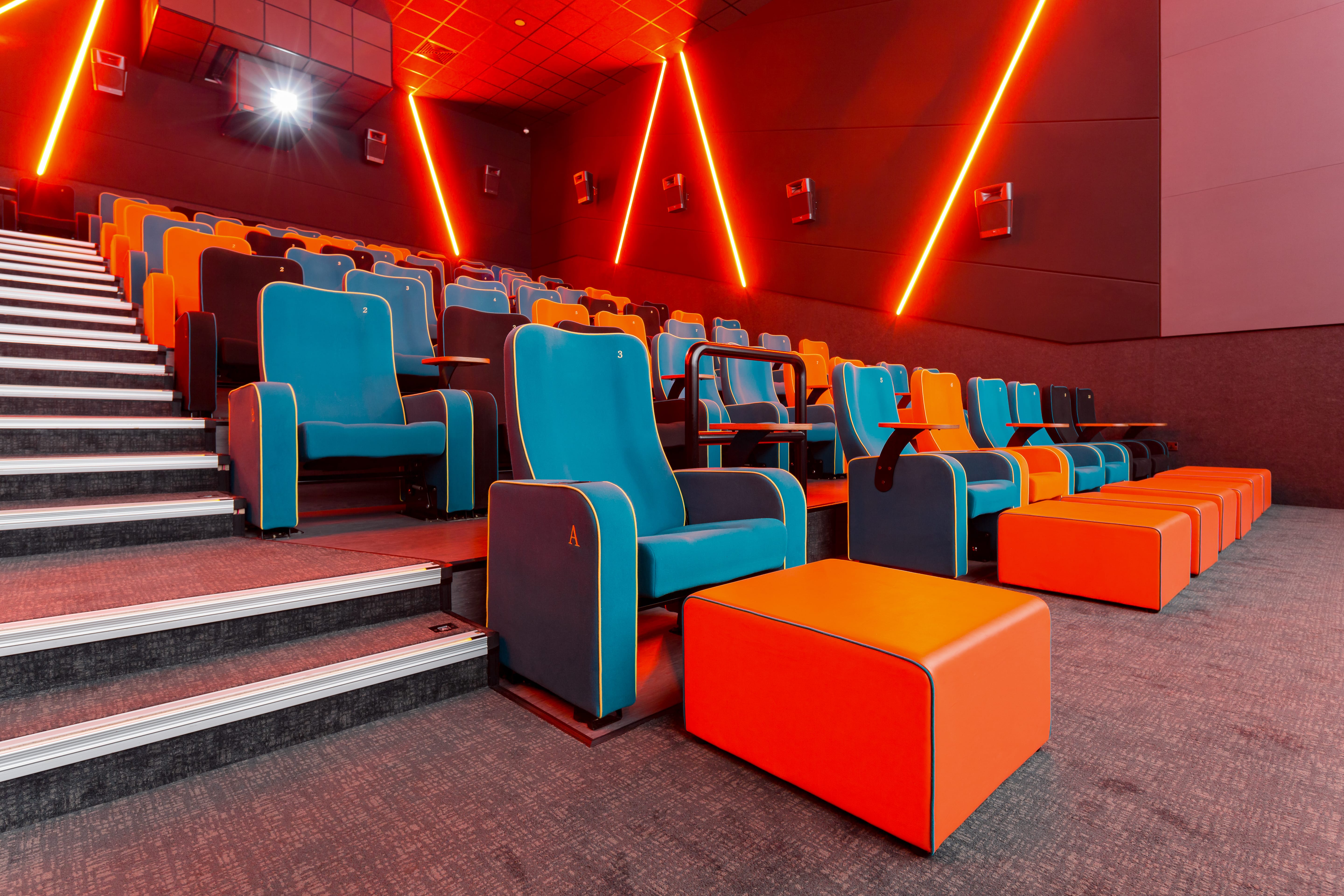 Modern auditorium with vibrant blue and orange seating for events in The Light Cinema Stockport.