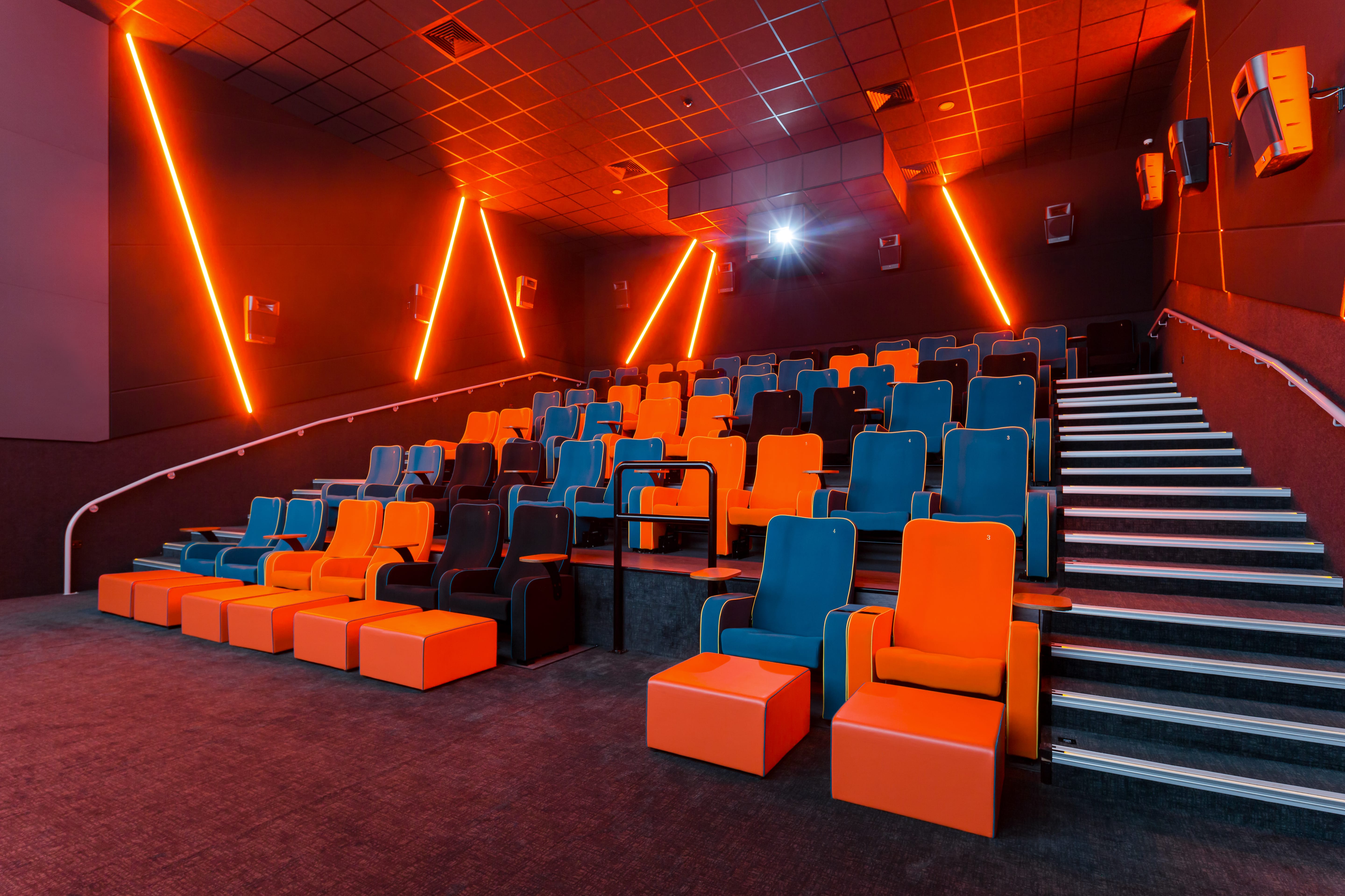 Modern auditorium with vibrant orange and blue seating for events in Stockport.