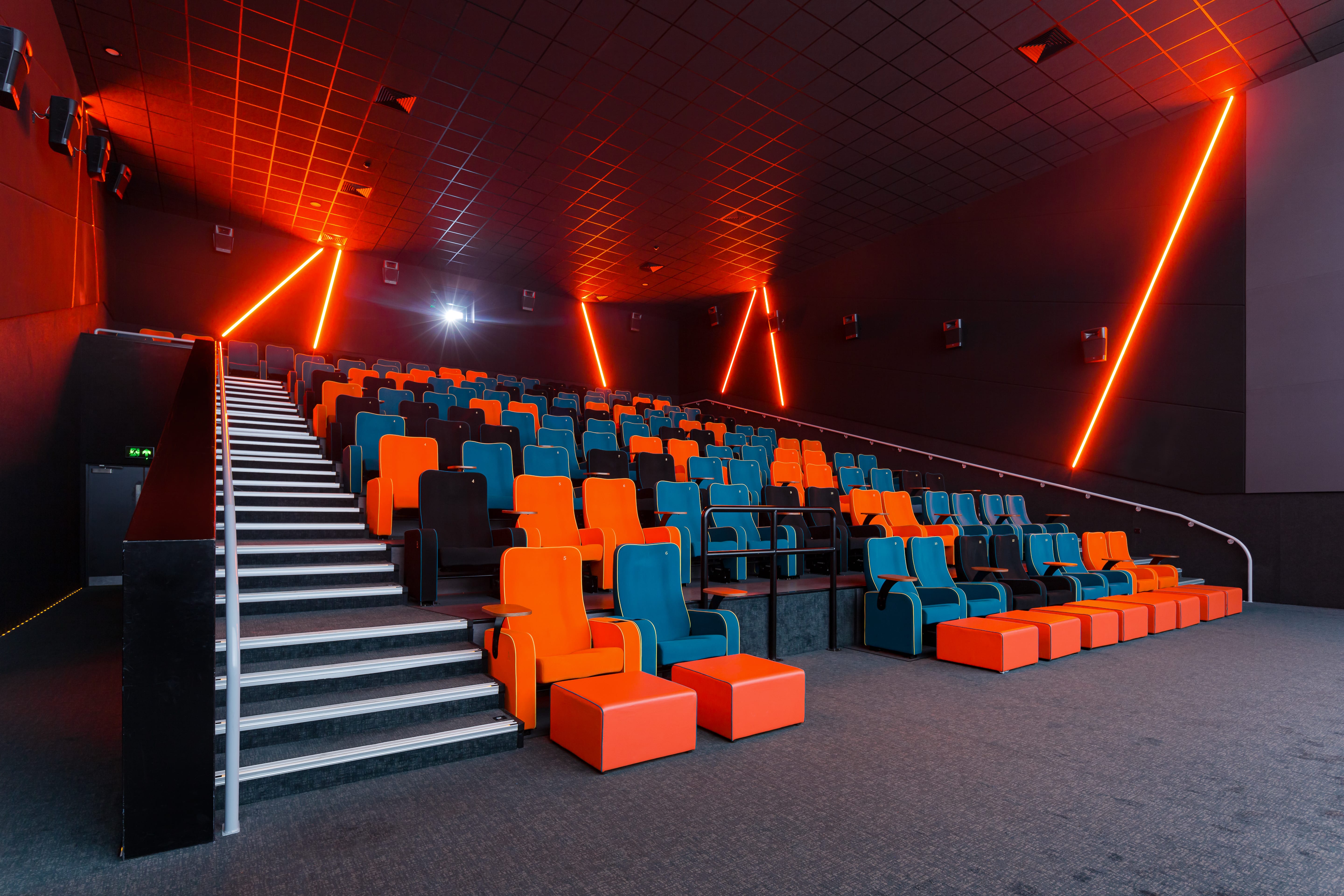 Modern auditorium with vibrant seating, ideal for screenings and corporate events.