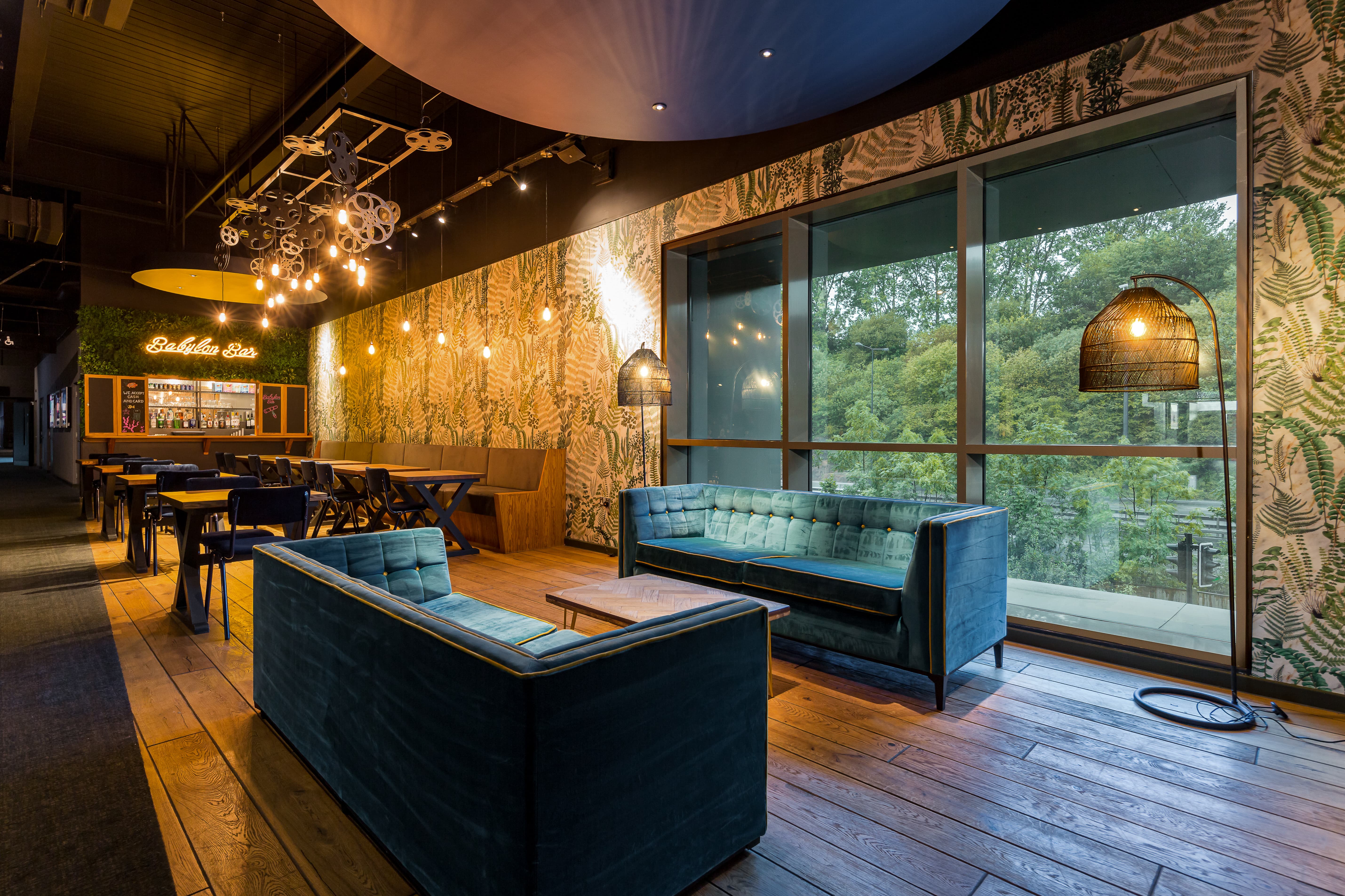 Stylish lounge at Babylon Bar, perfect for networking events with lush greenery and natural light.