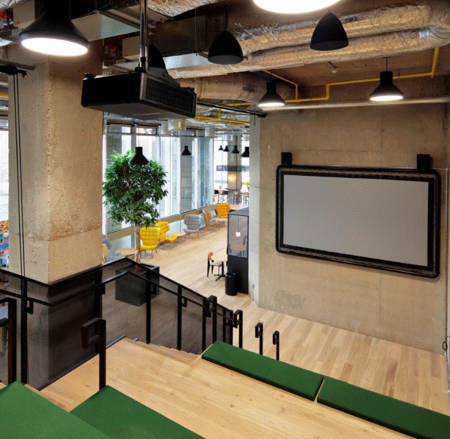 Modern event space with large screen, ideal for meetings and gatherings.