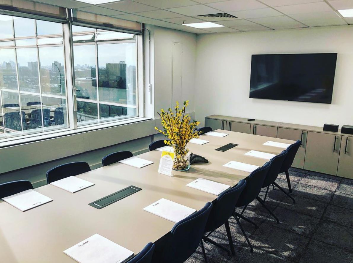 Whole Venue meeting room with long table, natural light, ideal for conferences and events.
