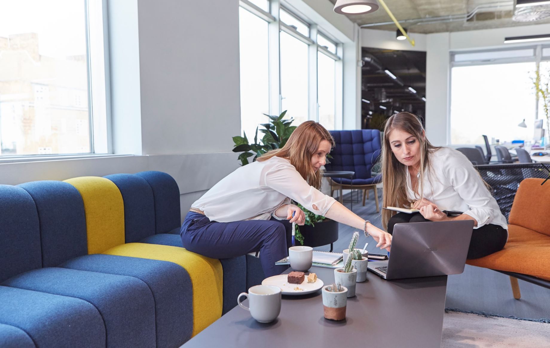 Collaborative workspace with colorful furniture for team-building events and workshops.