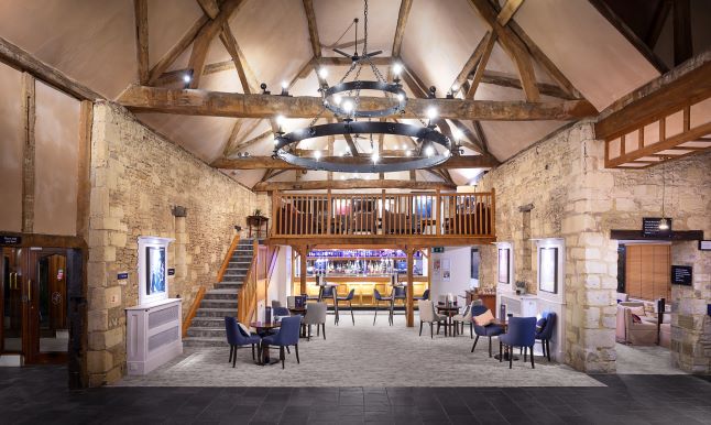 Elegant event space with wooden beams and chandelier at voco™ Oxford Thames Hotel.