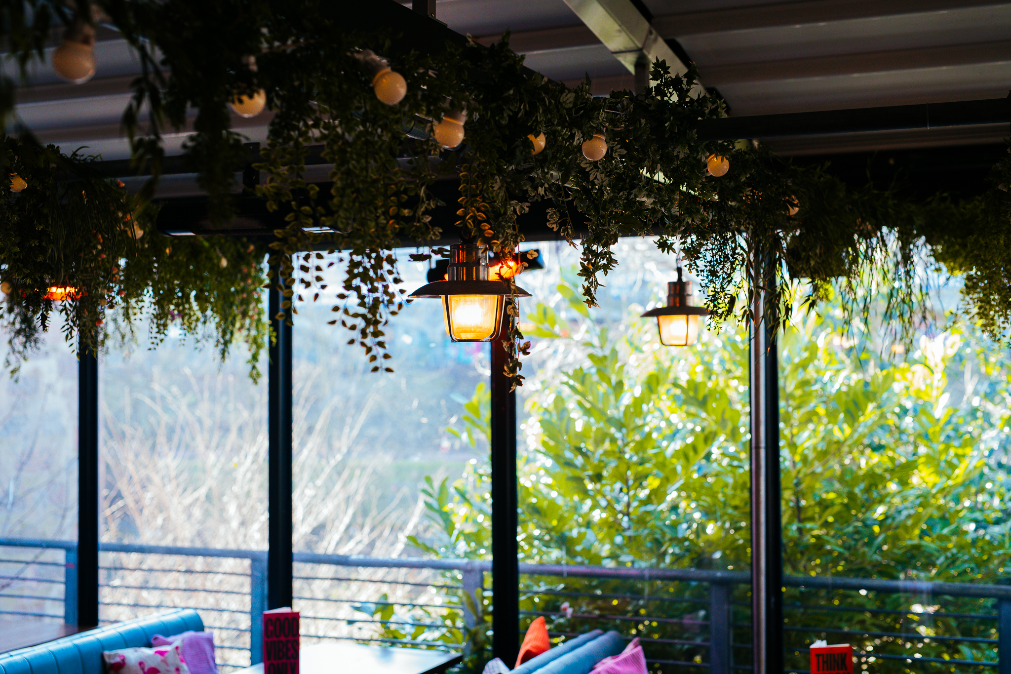 Event space at The Terrace, featuring lush greenery and warm lighting for weddings and networking.