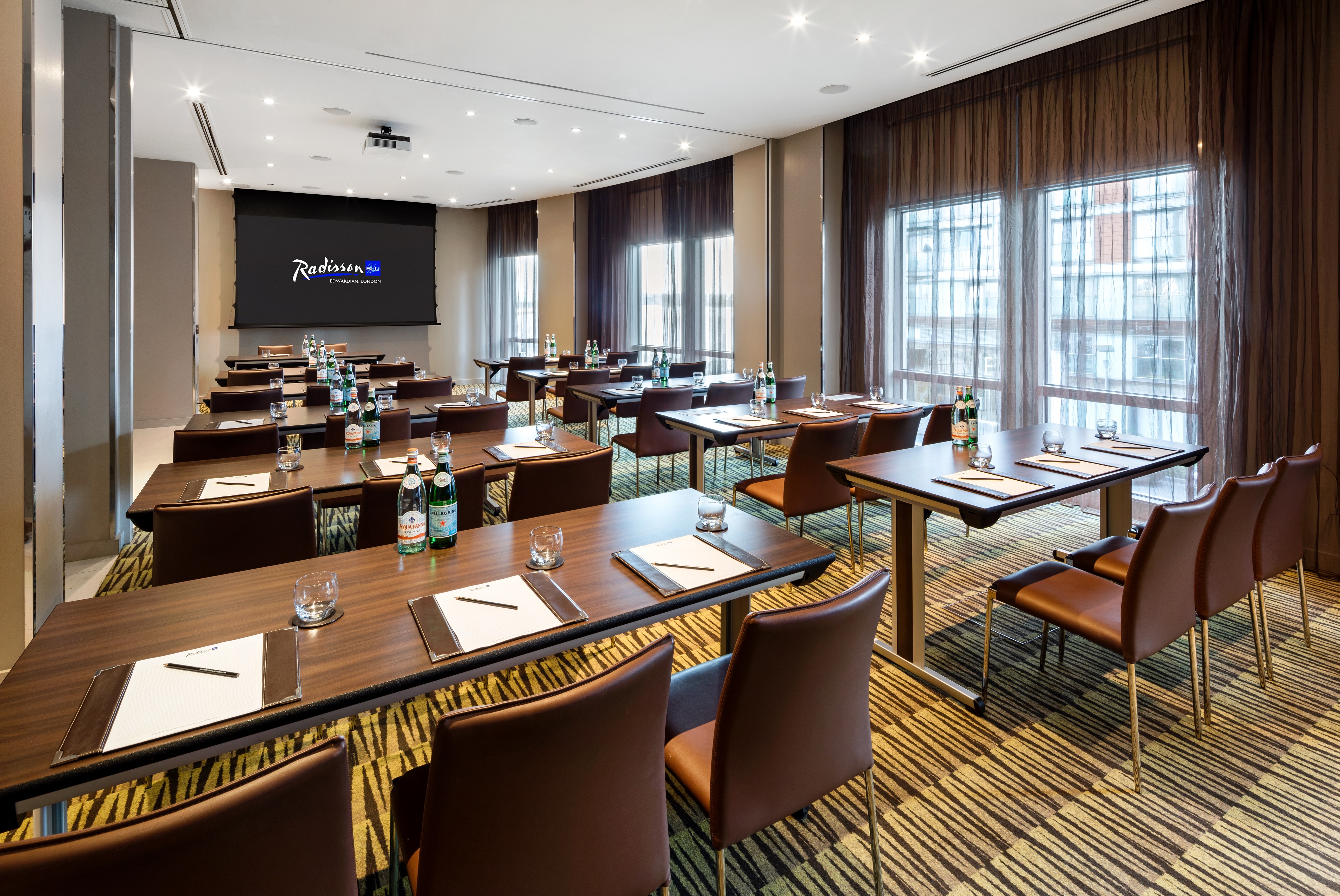 Private meeting room with natural light, ideal for workshops and presentations.