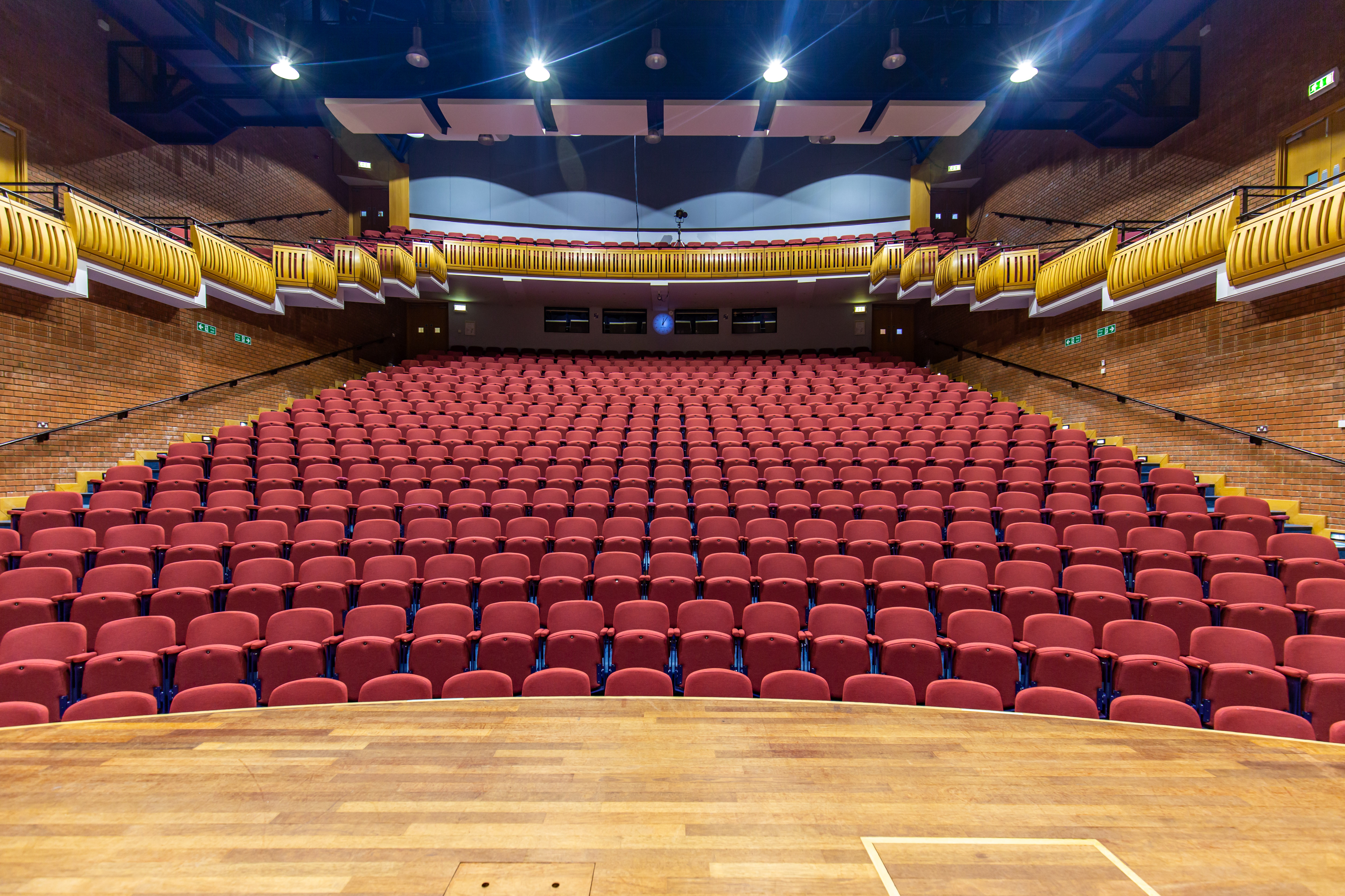 Spacious auditorium with tiered red seating for conferences and presentations in Marden Park.