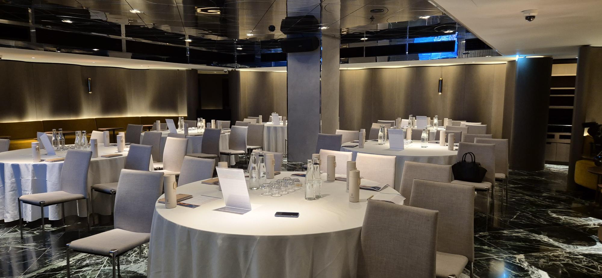 Tate Britain event space with round tables set for a professional conference or meeting.