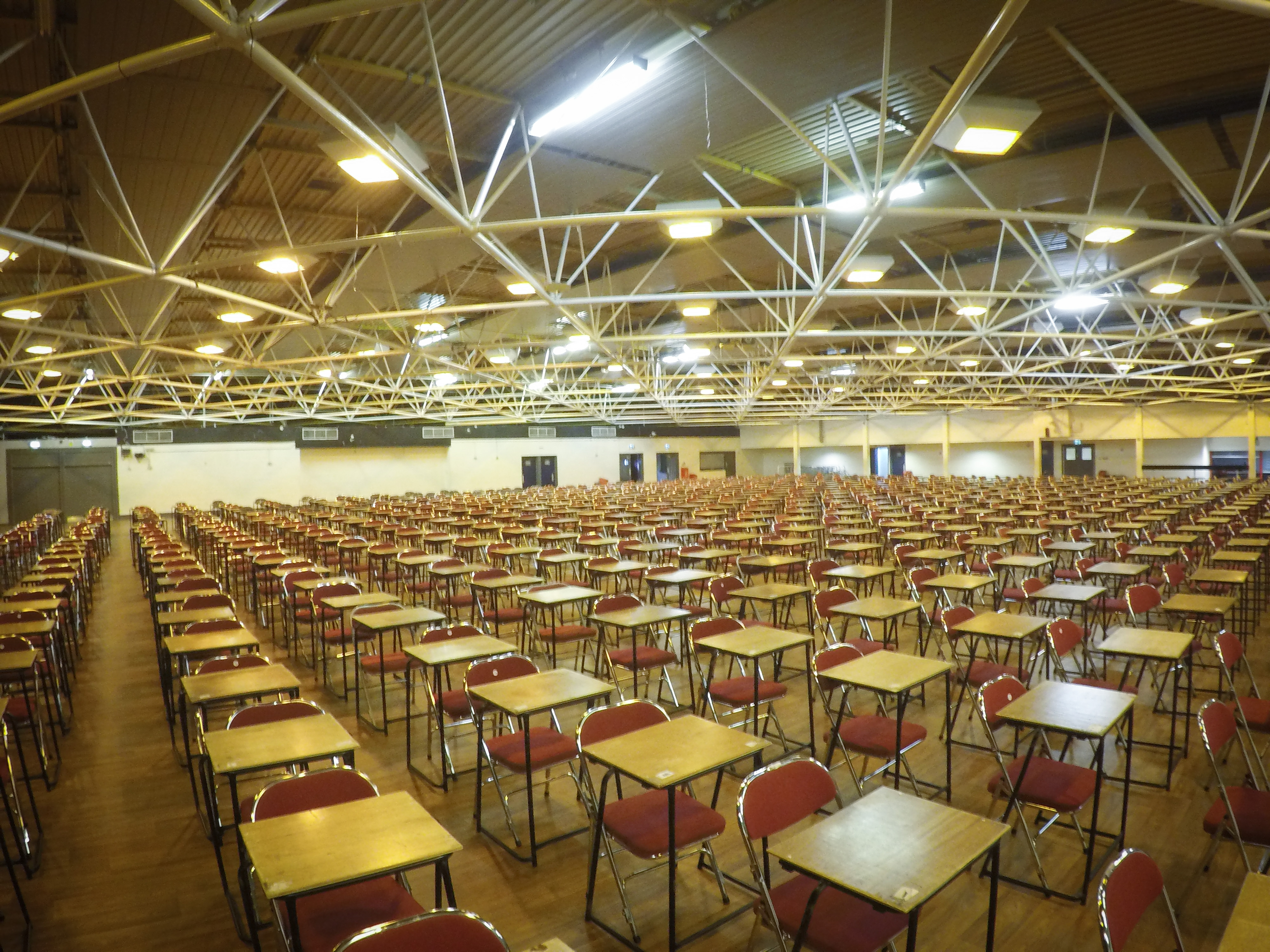 Spacious Byron Hall venue with rows of tables, ideal for conferences and exams.