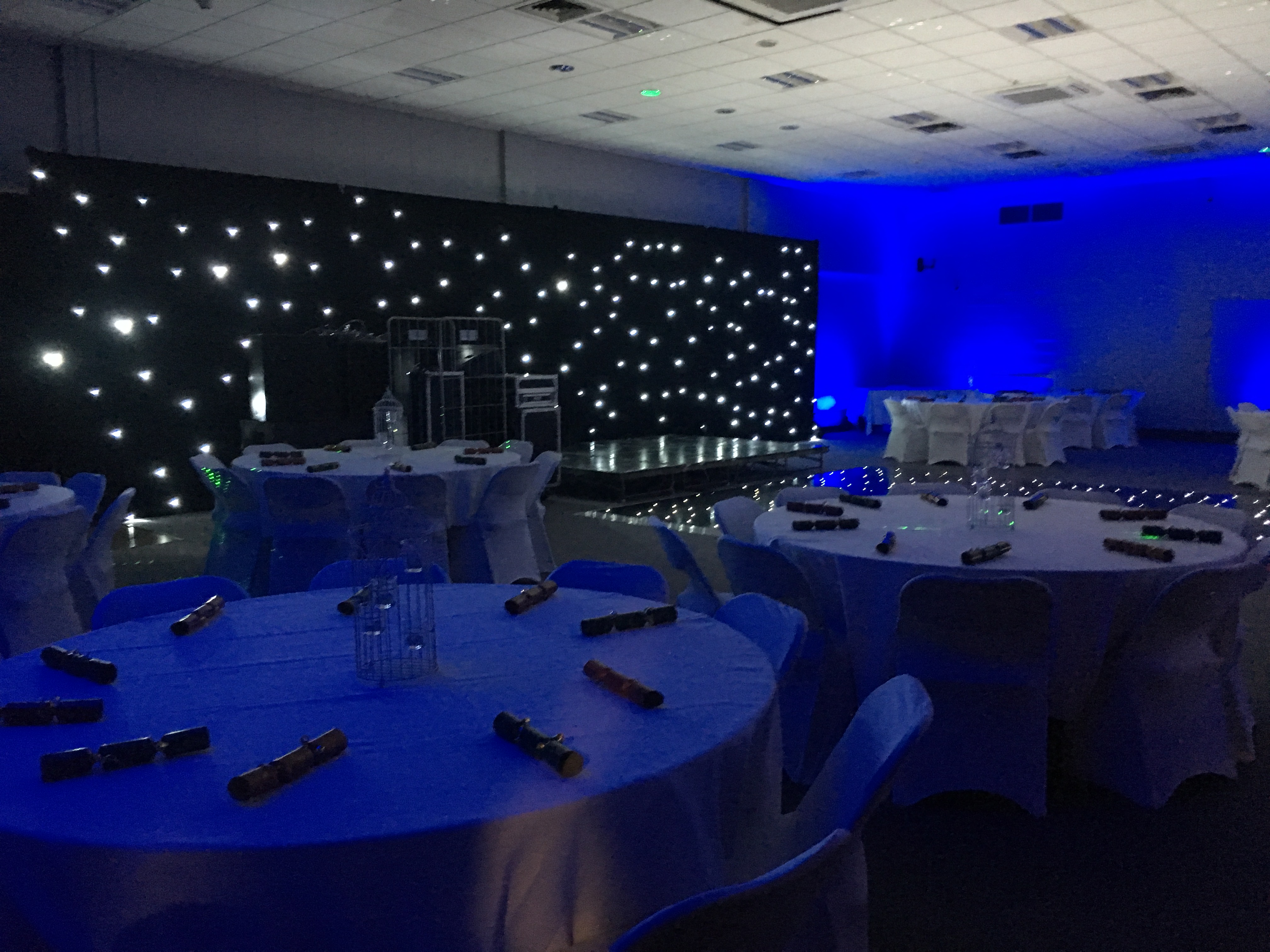 Elegant Masefield Suite venue with round tables and starry light display for formal events.