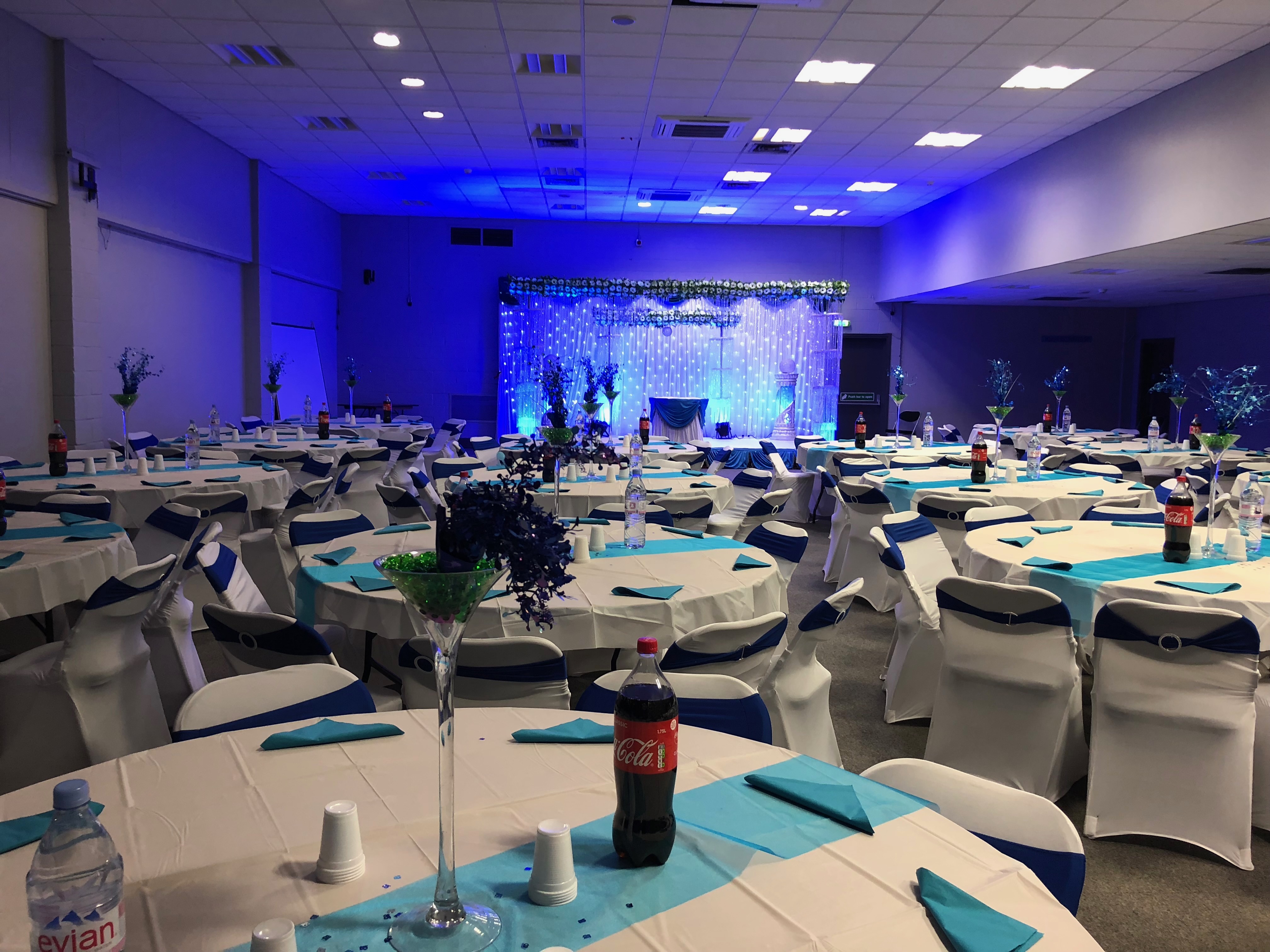 Elegant Masefield Suite venue set for formal gatherings with blue and white decor.