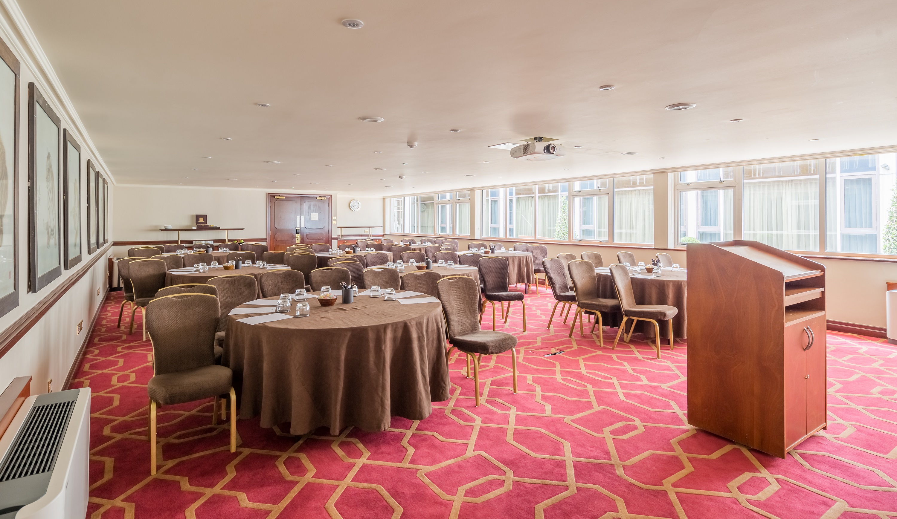 Private Room 11 at Radisson Blu Heathrow, ideal for conferences with round tables and projector.