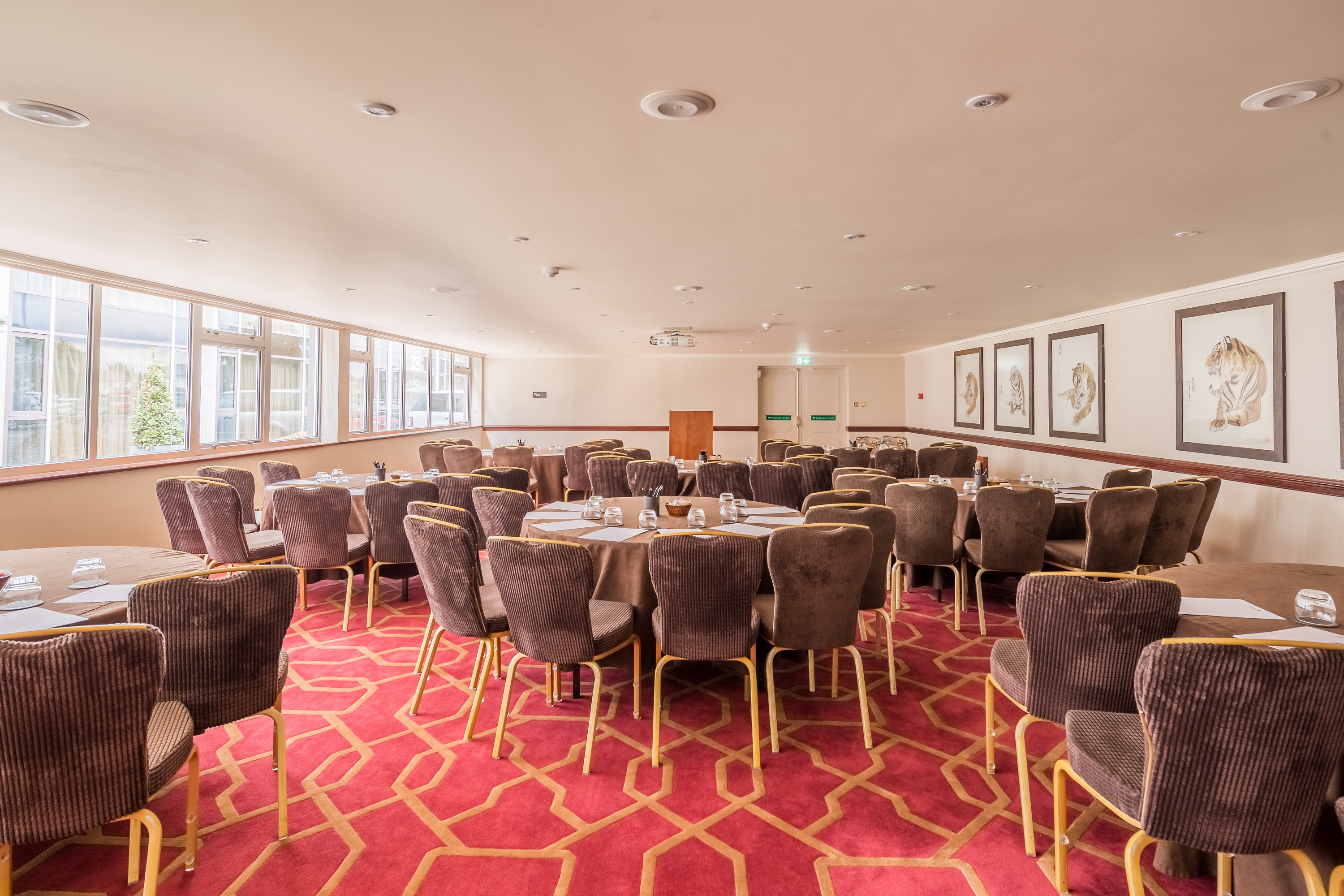 Private Room 11 at Radisson Blu Heathrow, elegant meeting space with round tables.
