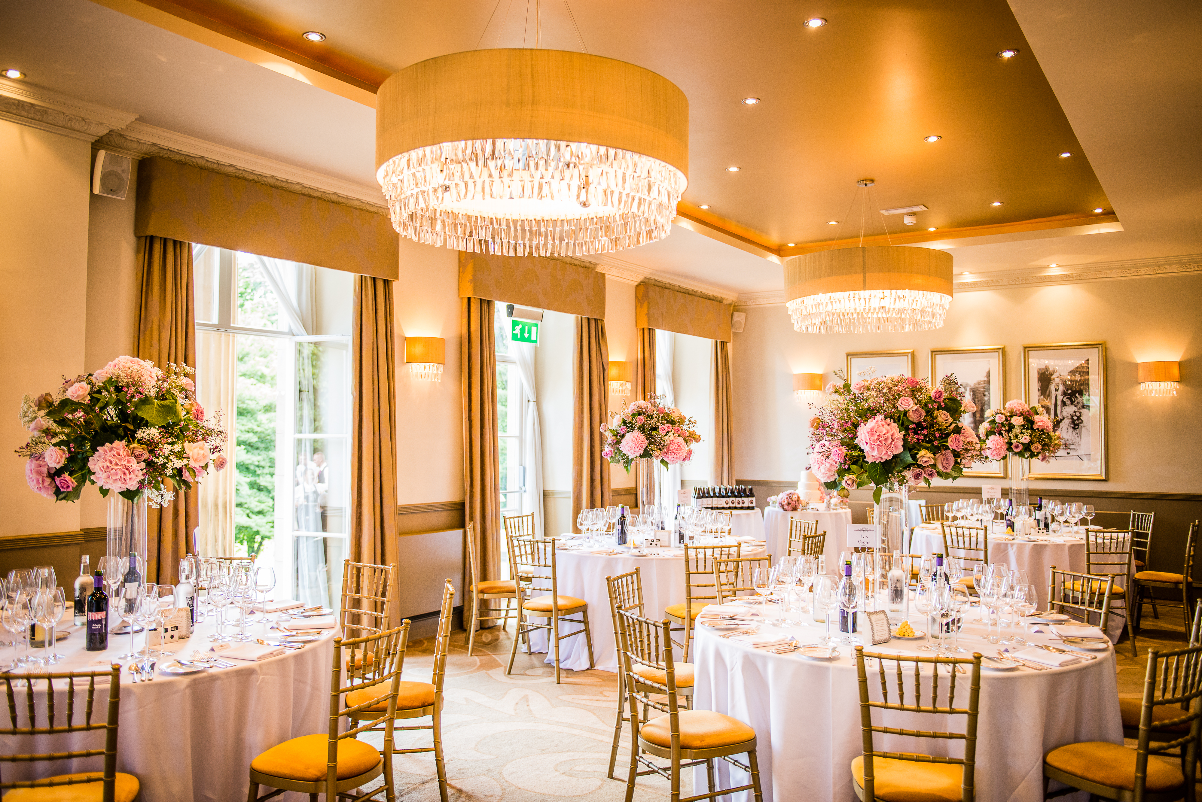 Elegant event space in The Mansion with round tables, ideal for weddings and corporate events.