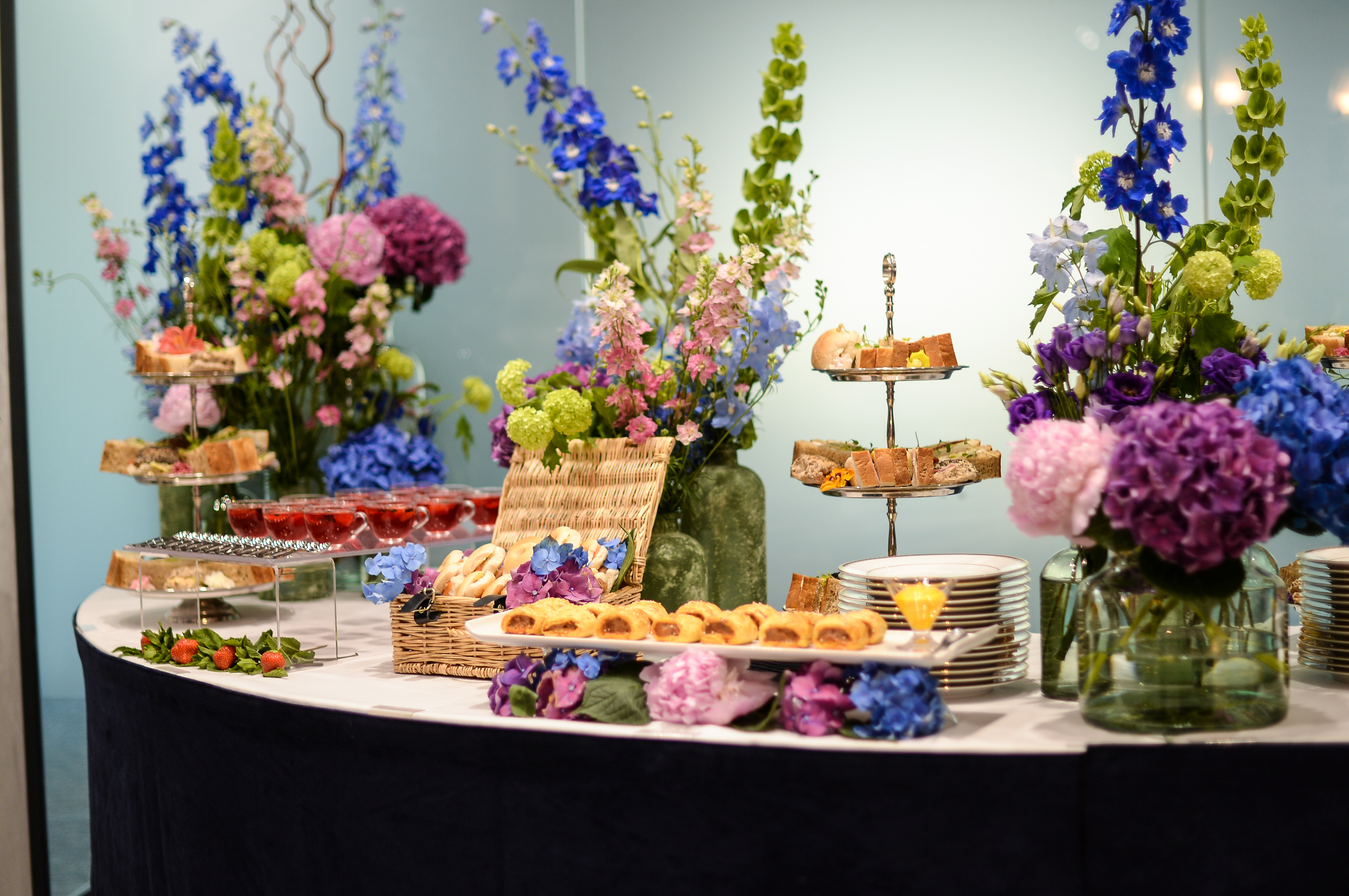 Elegant catering display with floral centerpieces for events and meetings at The Mansion.