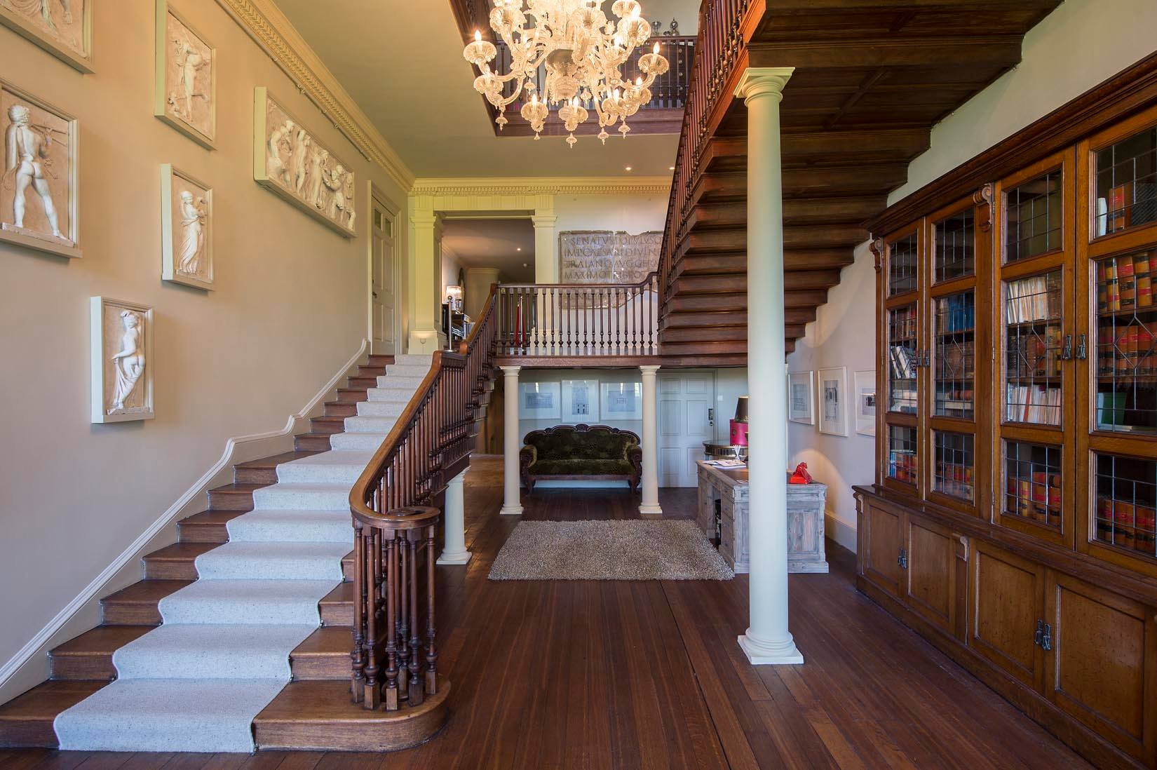 Elegant foyer with grand staircase at Howsham Hall, ideal for upscale events and gatherings.