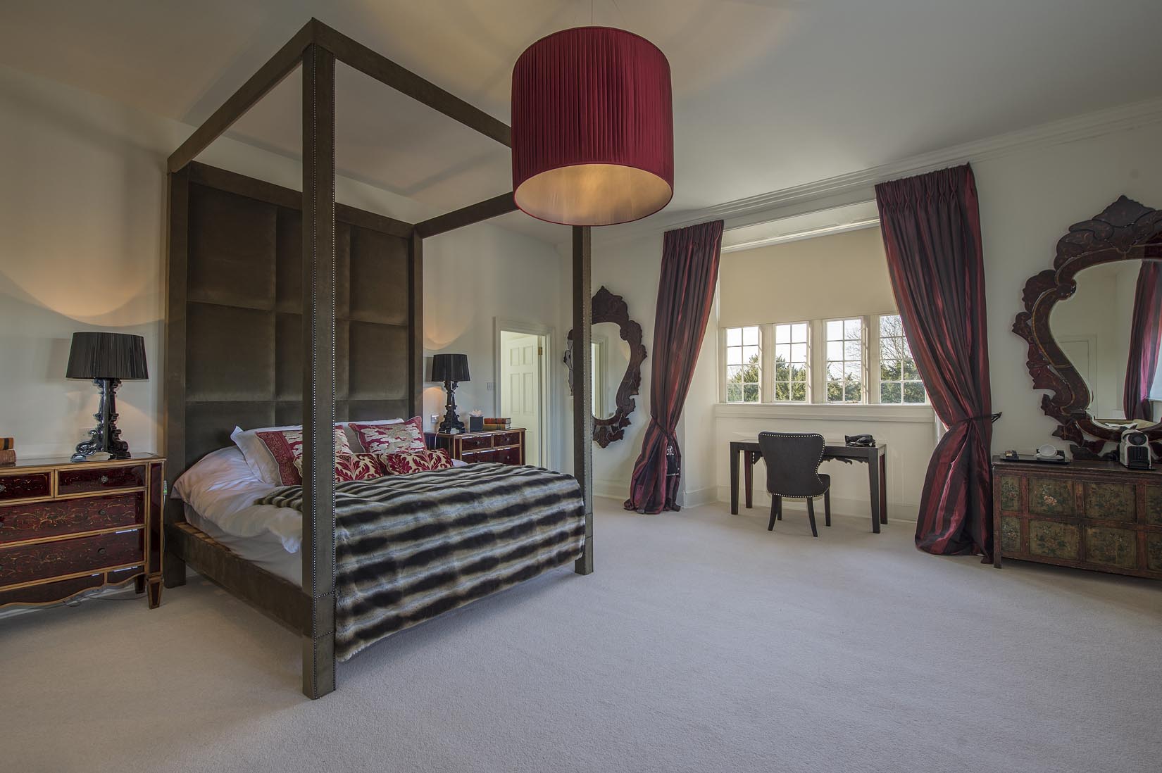 Elegant hotel room with four-poster bed, ideal for VIP events and business retreats.