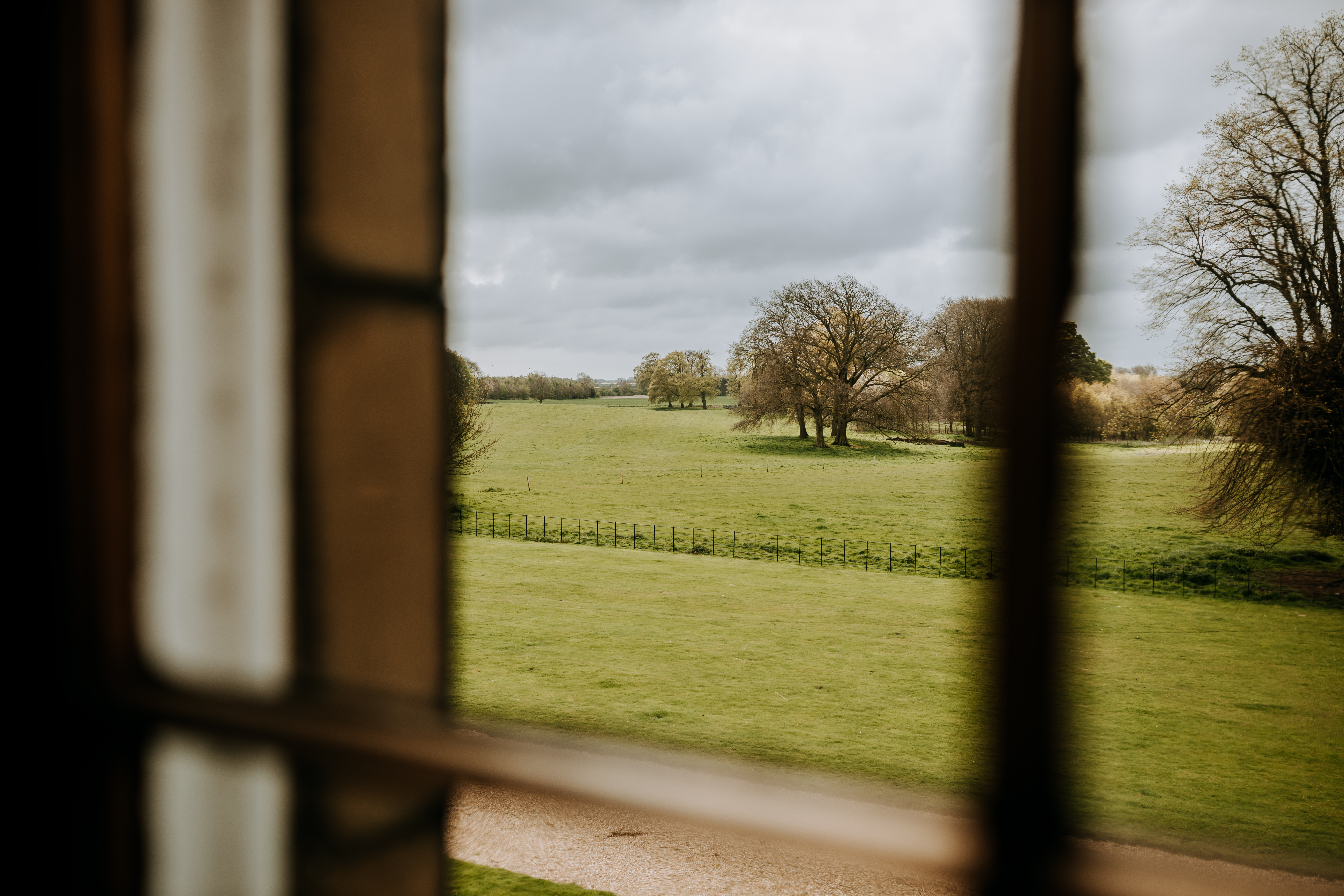 Serene Rise Hall venue with lush fields, ideal for outdoor retreats and gatherings.