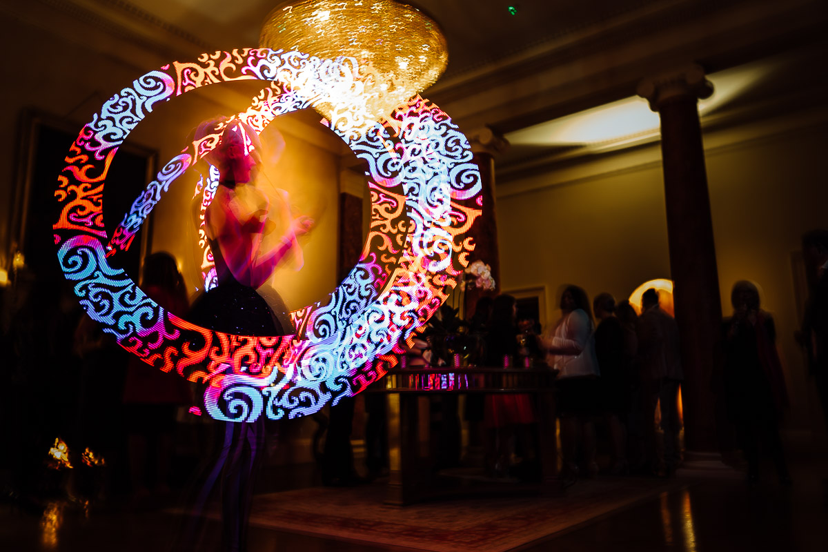 "Vibrant event at Rise Hall with illuminated performer, ideal for networking and entertainment."