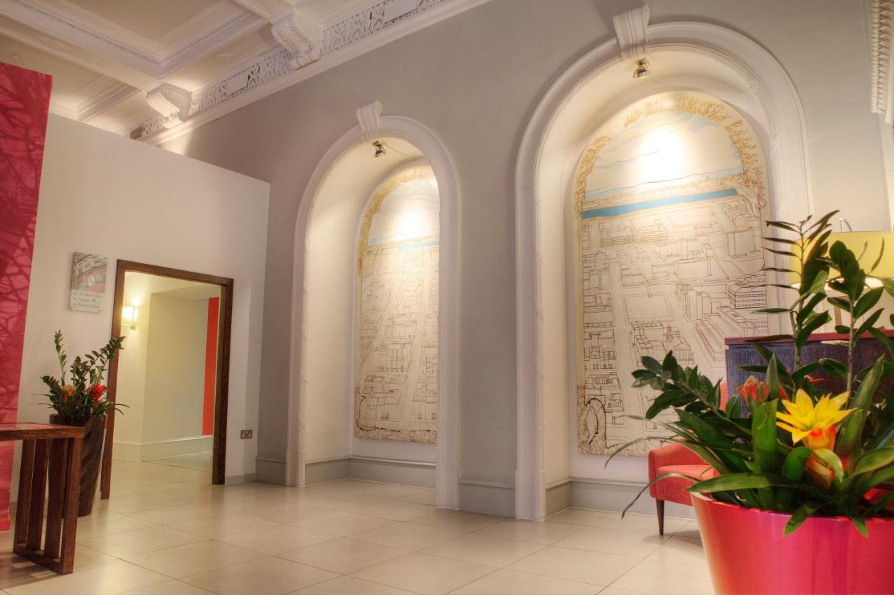 Elegant Lounge Bar at Hotel Indigo Glasgow with arched niches, ideal for events and networking.