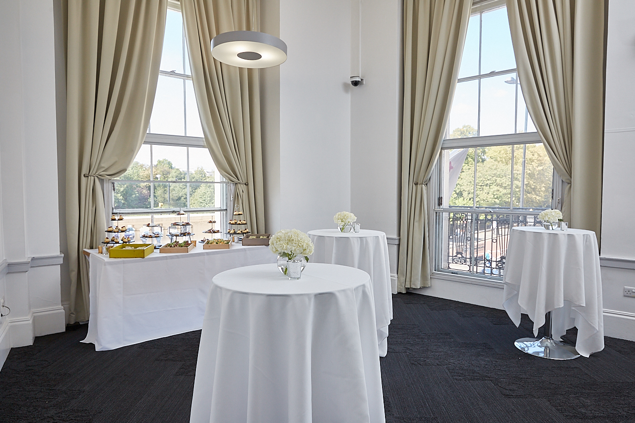 Elegant event space with high-top tables, ideal for networking and cocktail receptions.