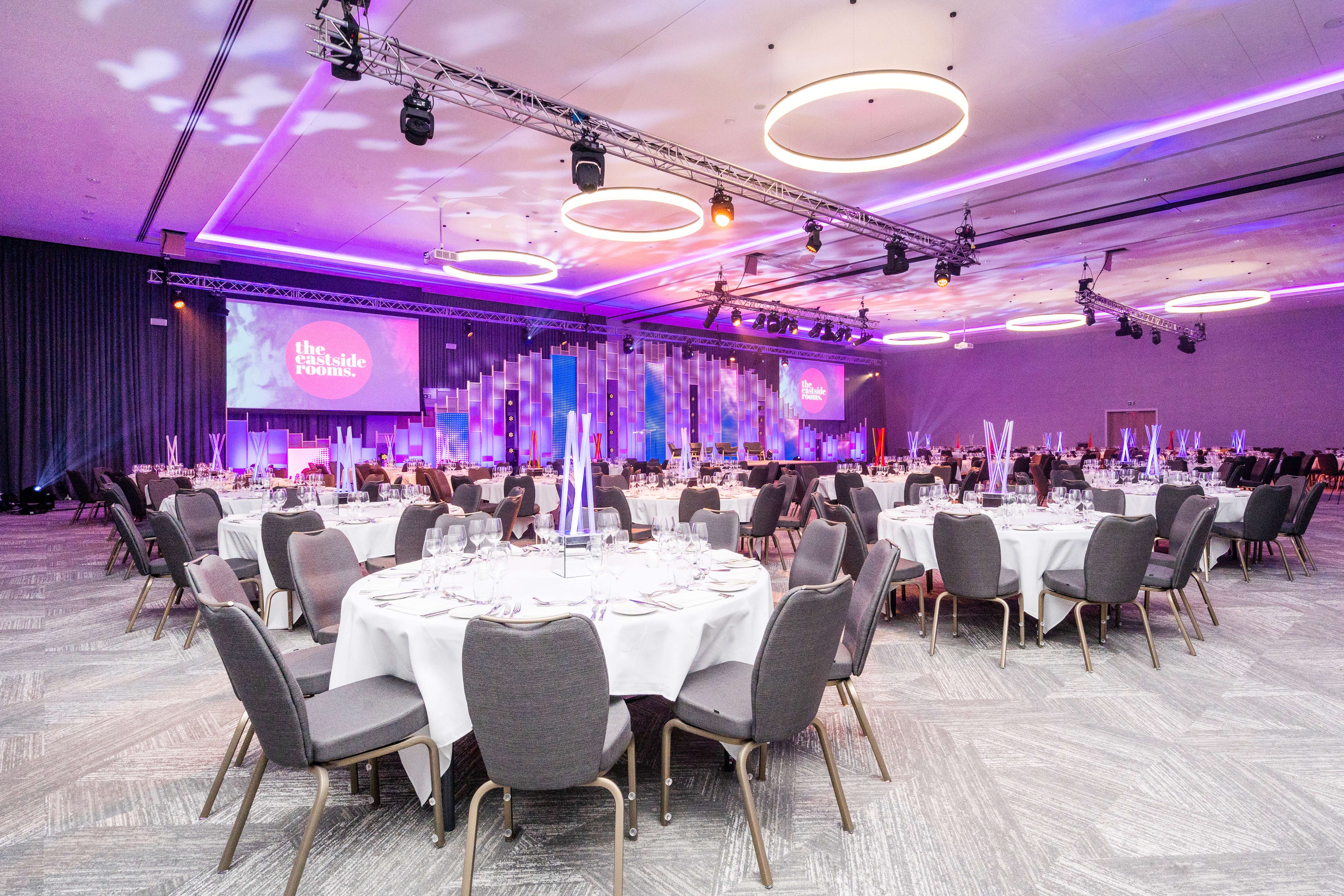 Elegant banquet hall with round tables, perfect for corporate events and gala dinners.