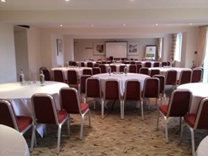 Cambridge Suite meeting room with round tables, ideal for events and presentations.