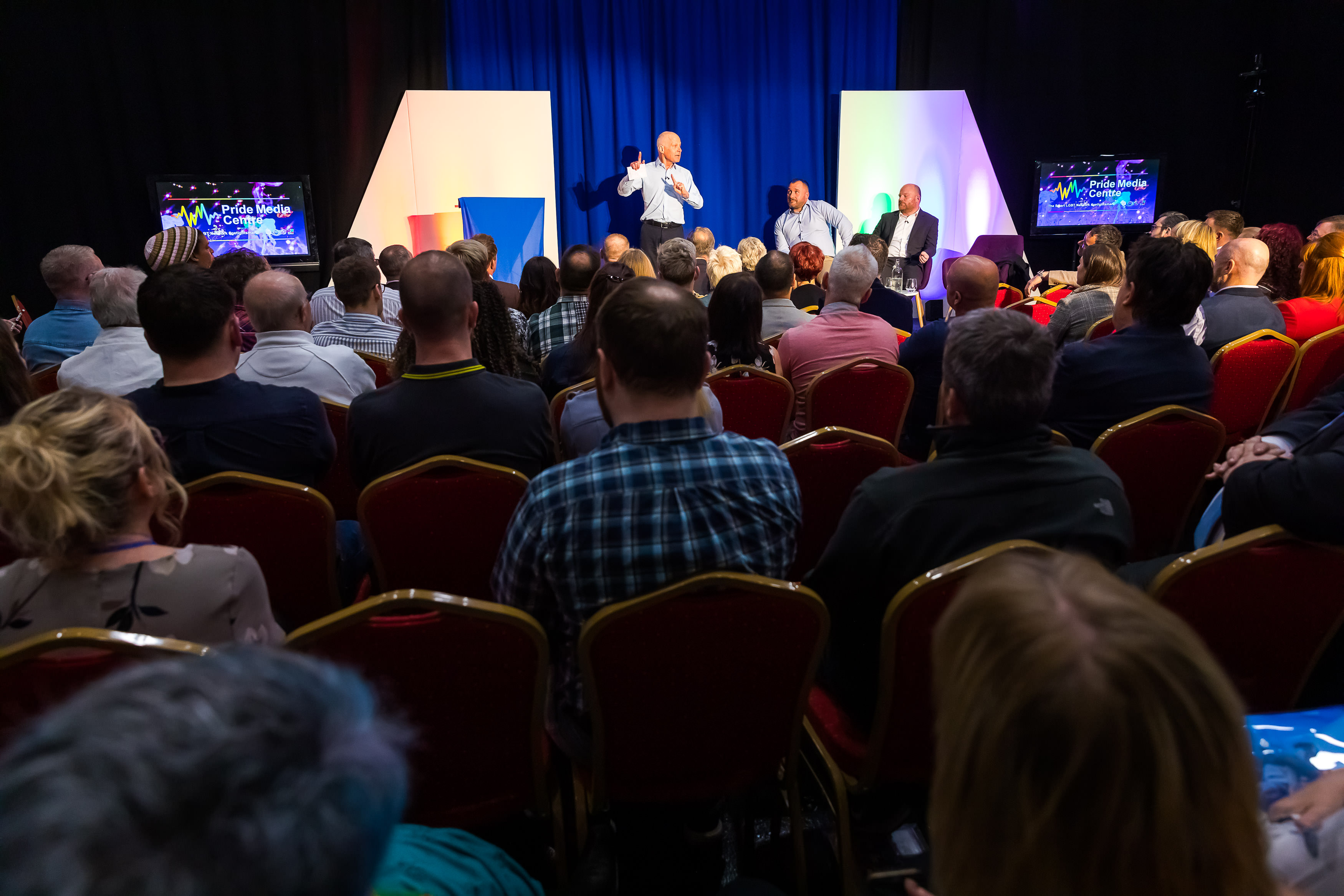 Engaged audience at a vibrant conference in Pride Media Centre TV studio.