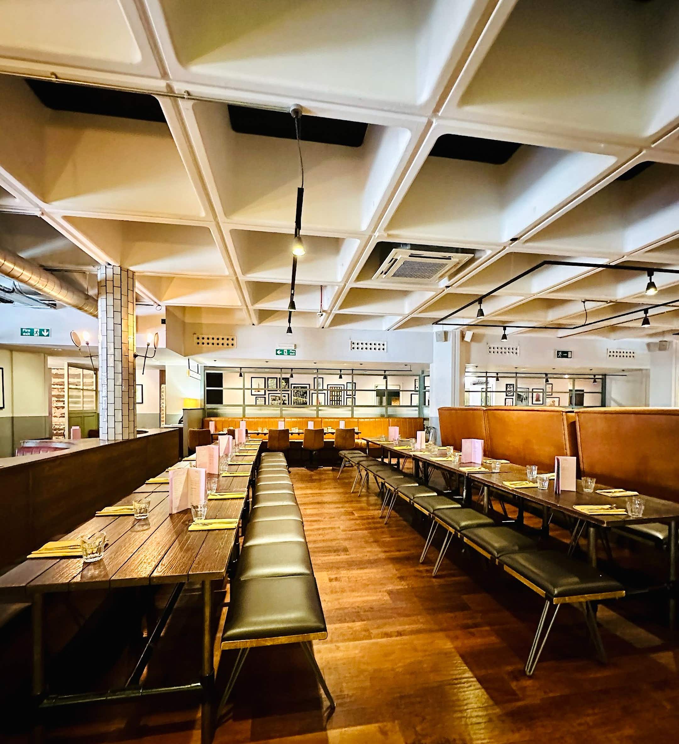 Spacious Main Hall at All Star Lanes, ideal for events with modern decor and warm lighting.