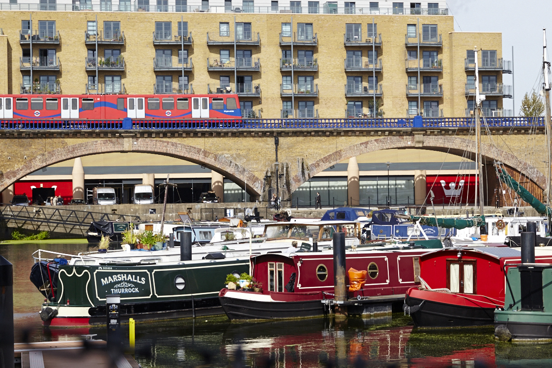Yurt Cafe waterfront venue with colorful boats, perfect for outdoor events in St Katharine's.
