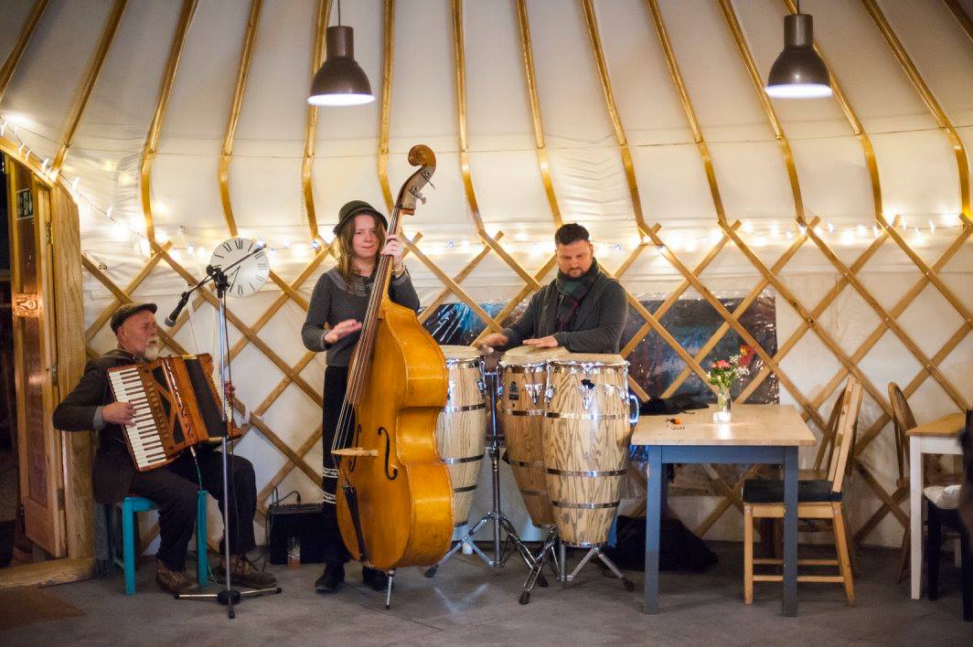 Yurt Cafe live music performance in cozy rustic setting, ideal for events and gatherings.