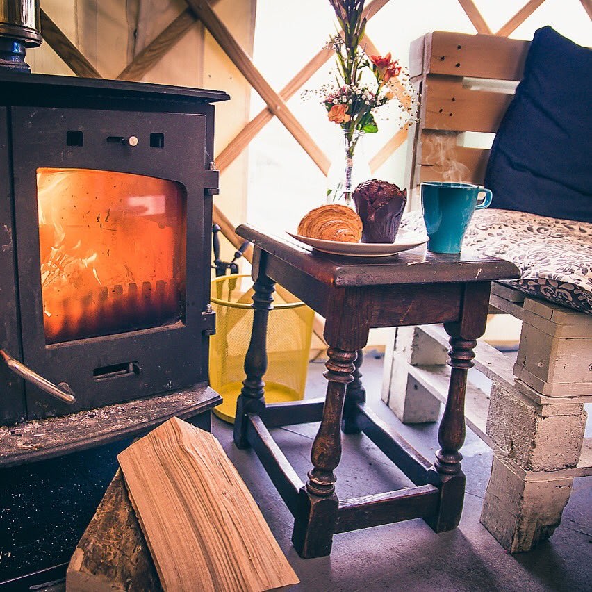 Cozy Yurt Cafe with wood stove, ideal for intimate meetings and gatherings.