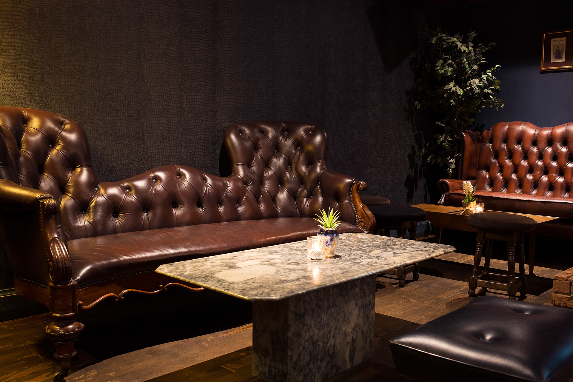 Stylish lounge with tufted leather sofas, ideal for networking events and meetings.