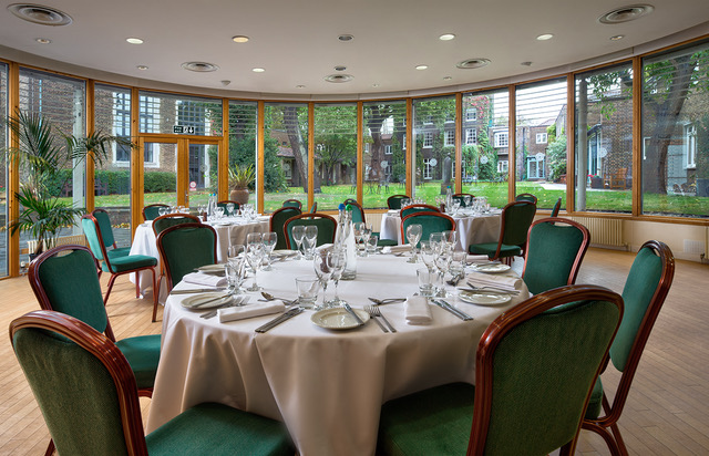 Queen Elizabeth Conference room with round tables, ideal for meetings and events.