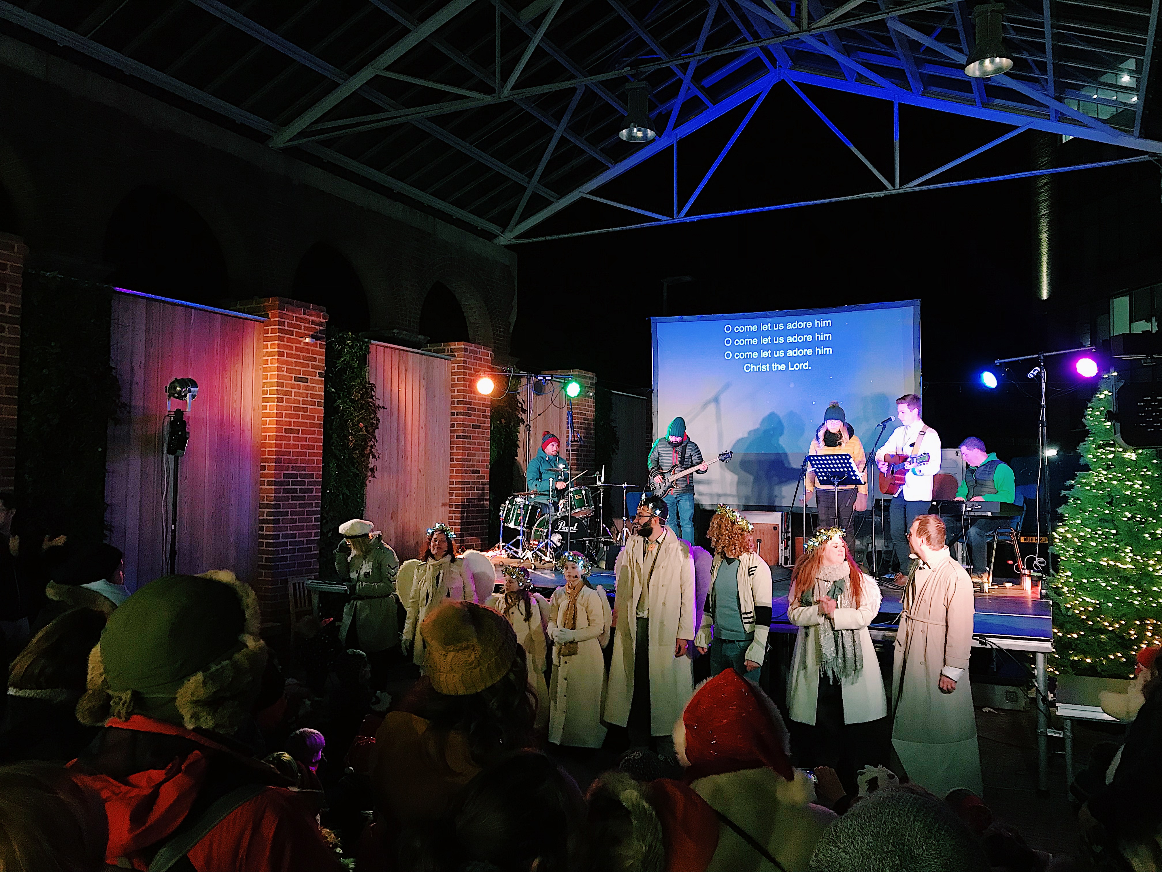 Vibrant outdoor event at The Carriage Shed with live music and festive decorations.