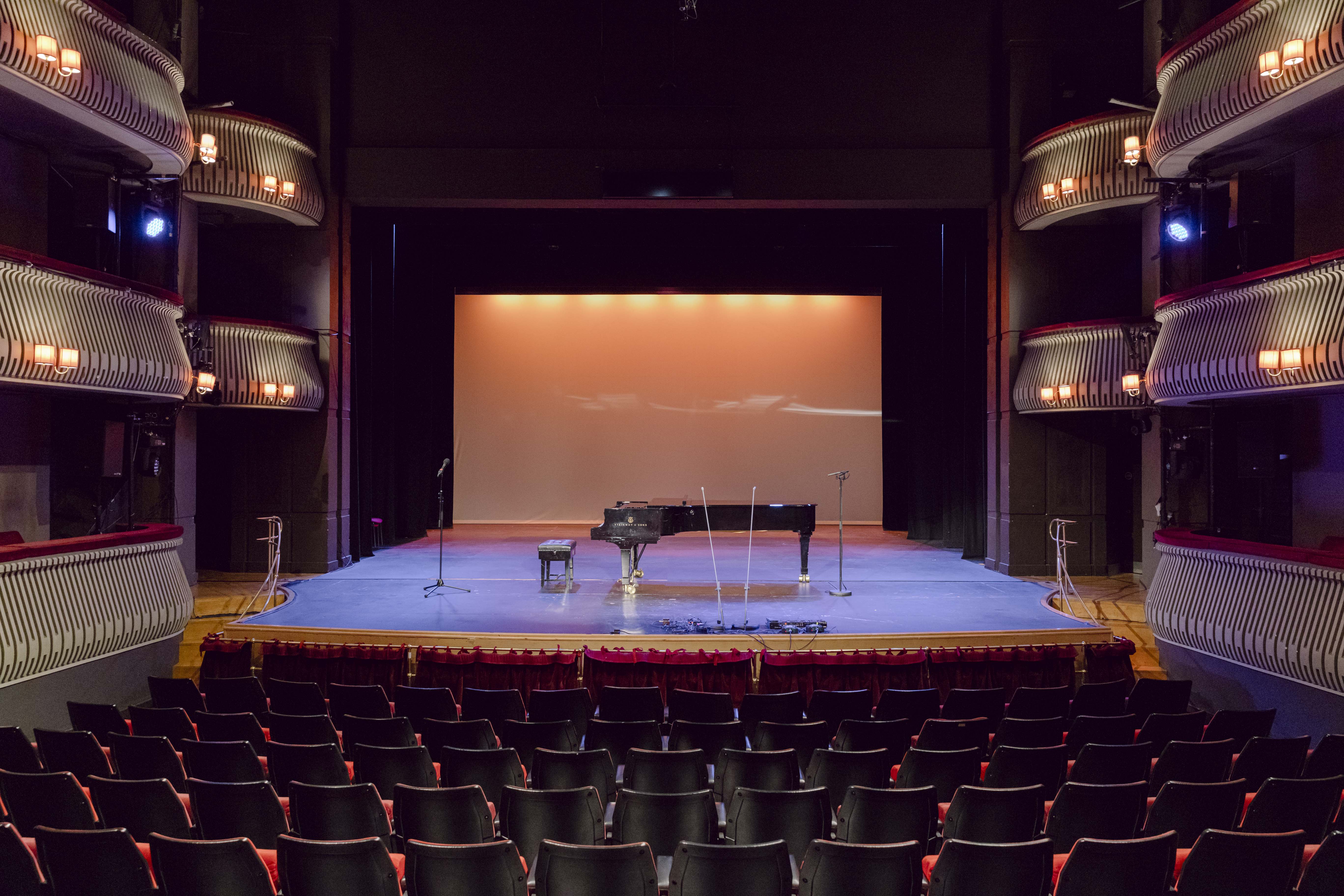 Britten Theatre stage with grand piano, ideal for concerts and performances.