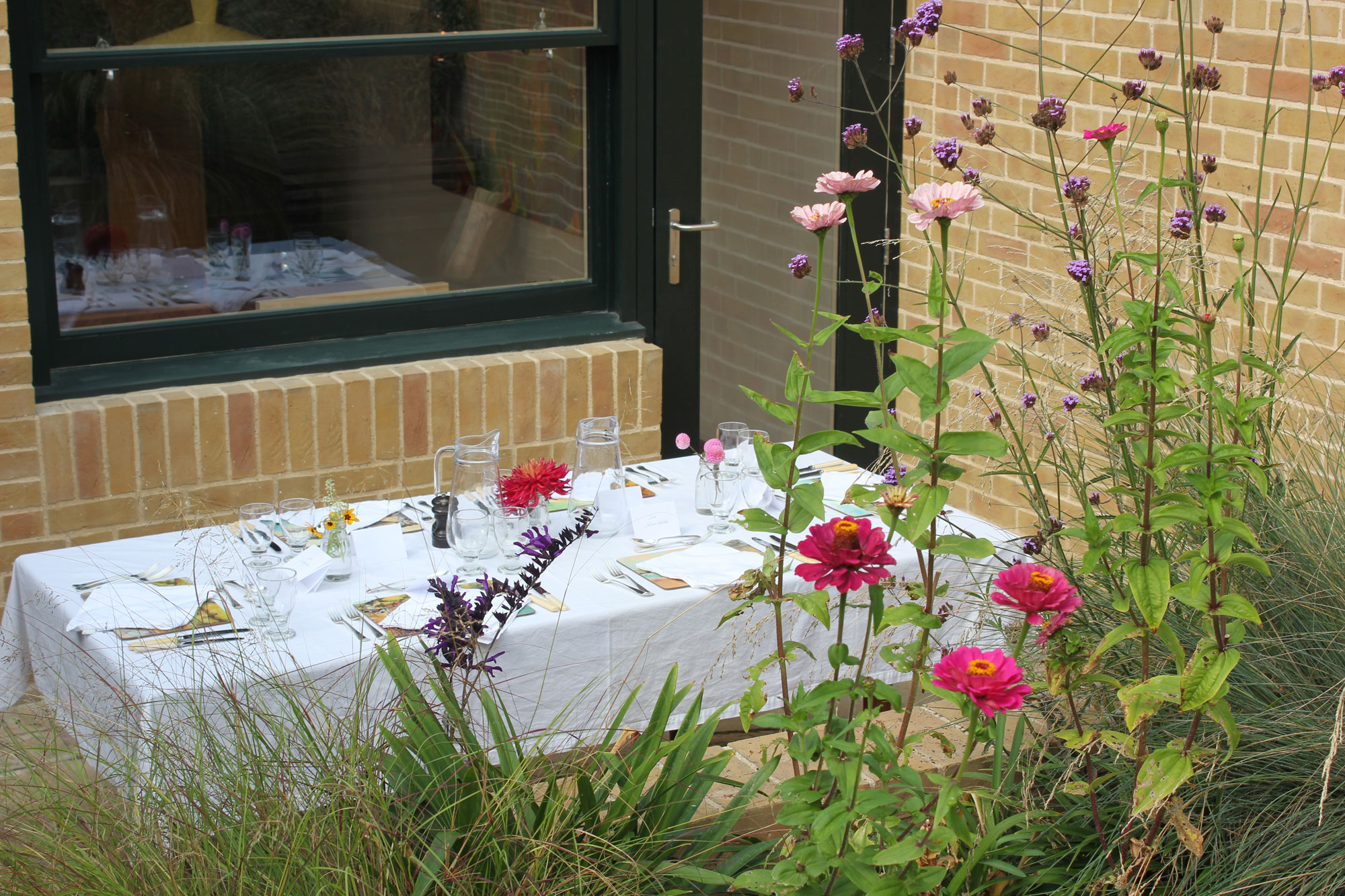 Elegant outdoor dining table in Van Gogh House garden, perfect for gatherings and events.
