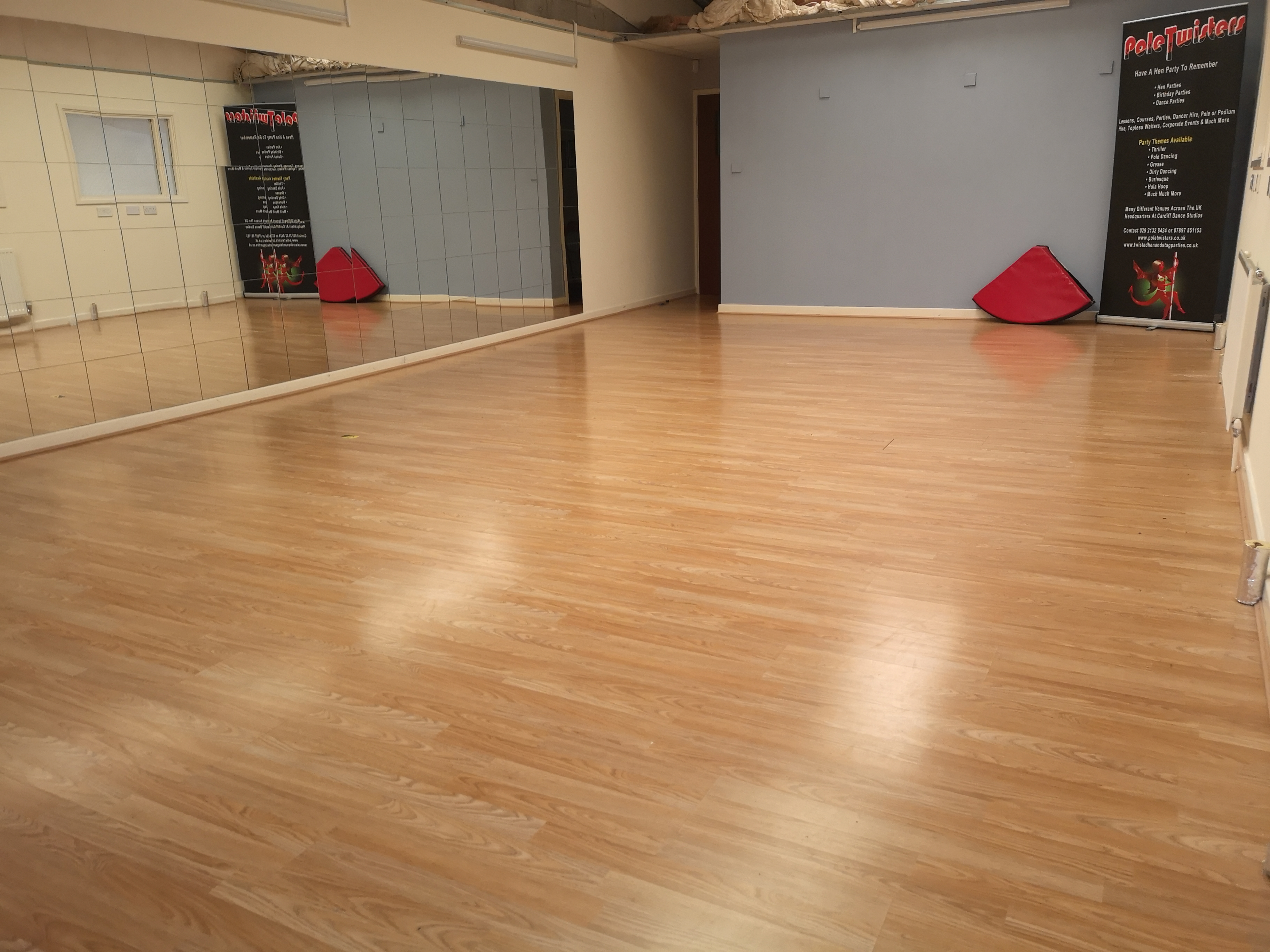 Spacious Pole Twisters Dance Studio with polished wood floor, ideal for workshops and fitness classes.