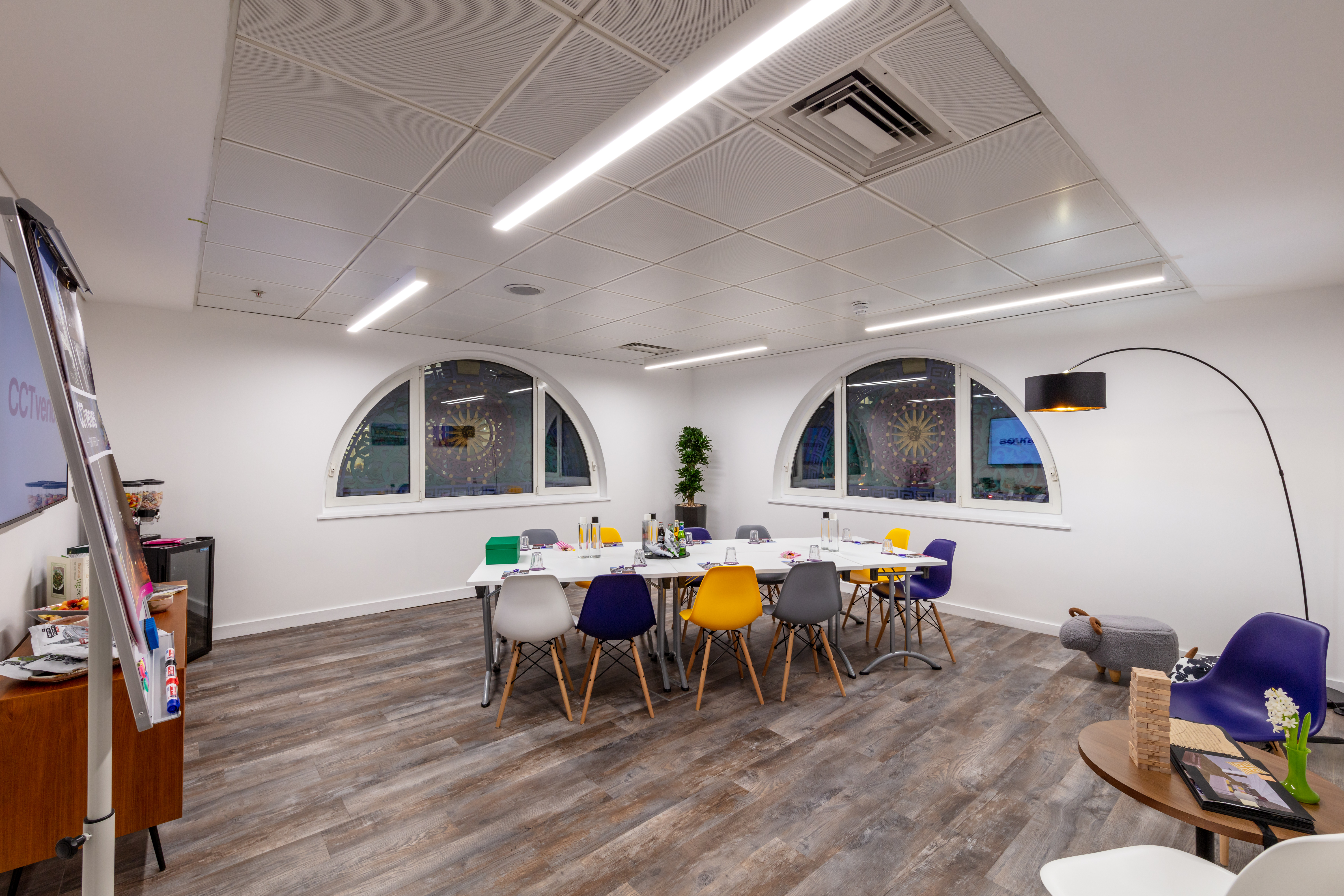 Modern meeting space at Camden Lock, bright with colorful chairs for workshops and brainstorming.