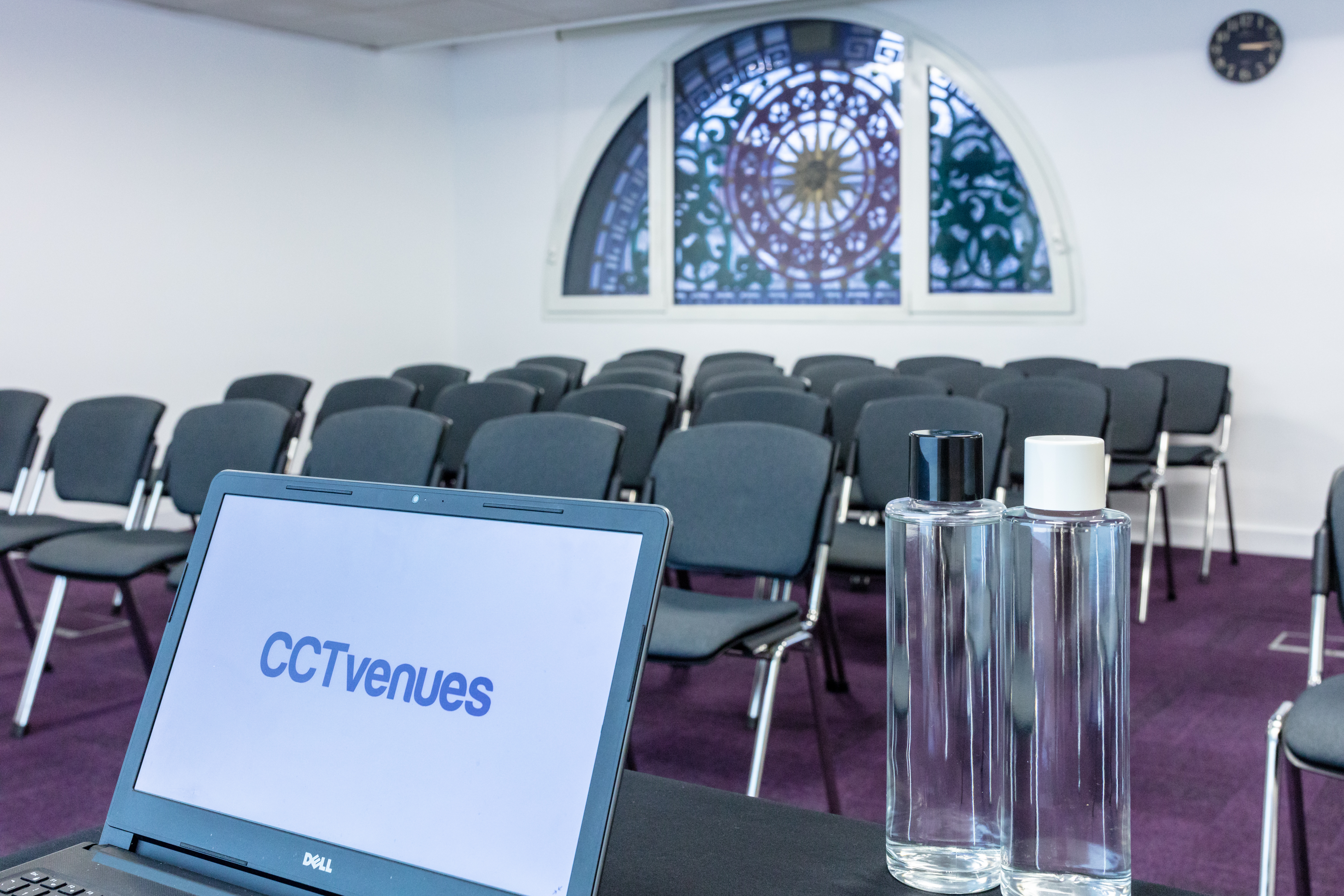 Covent Garden meeting space with laptop, stained glass, ideal for presentations and events.