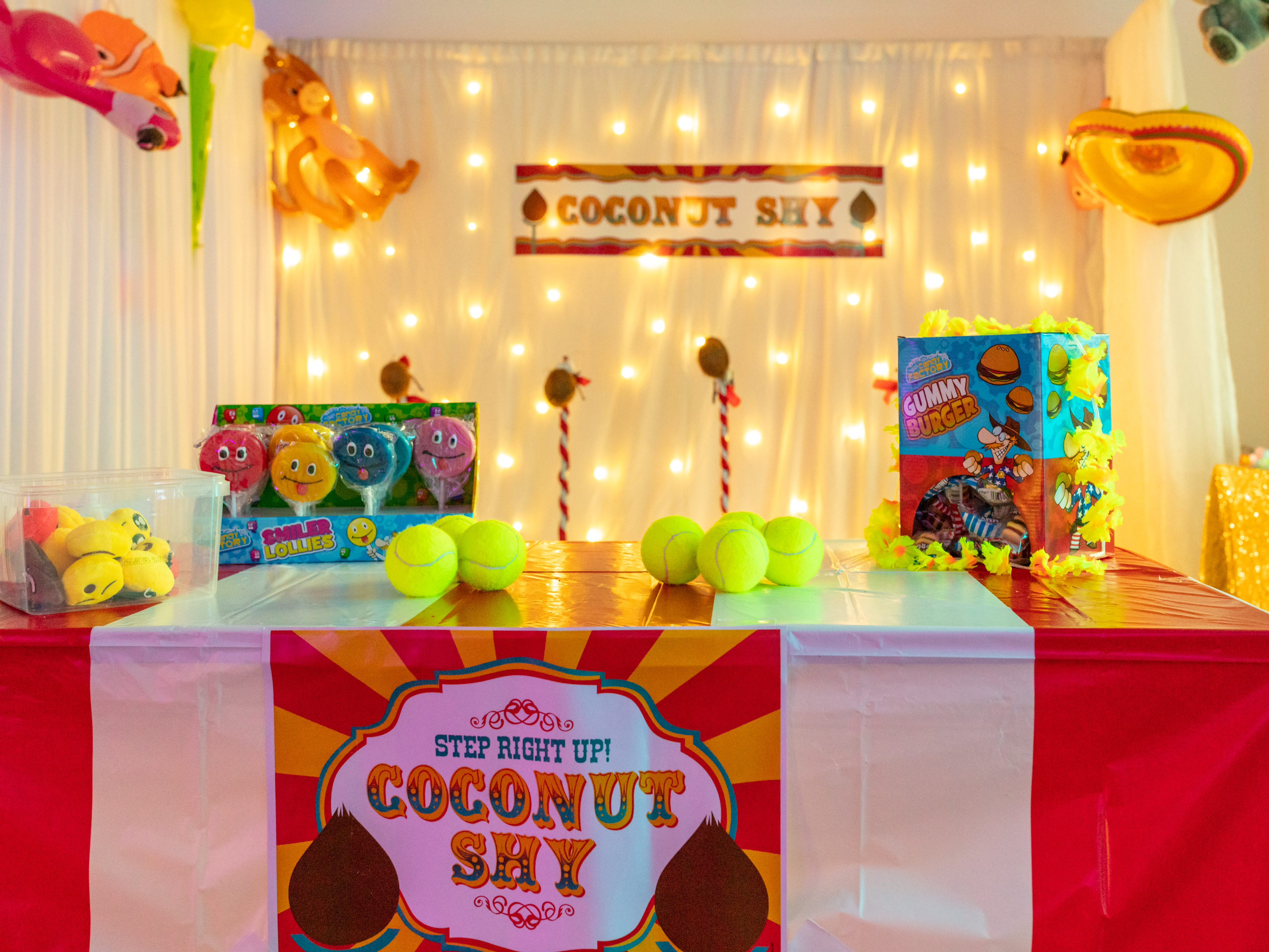 Carnival-themed Coconut Shy booth in Covent Garden, perfect for festive events and family fun.