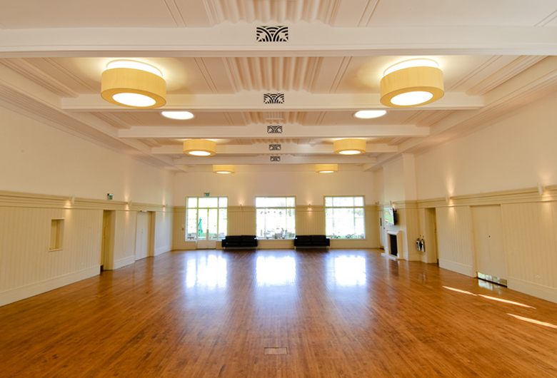Spacious function room with polished wooden floors for events at Dukes Meadows Golf.