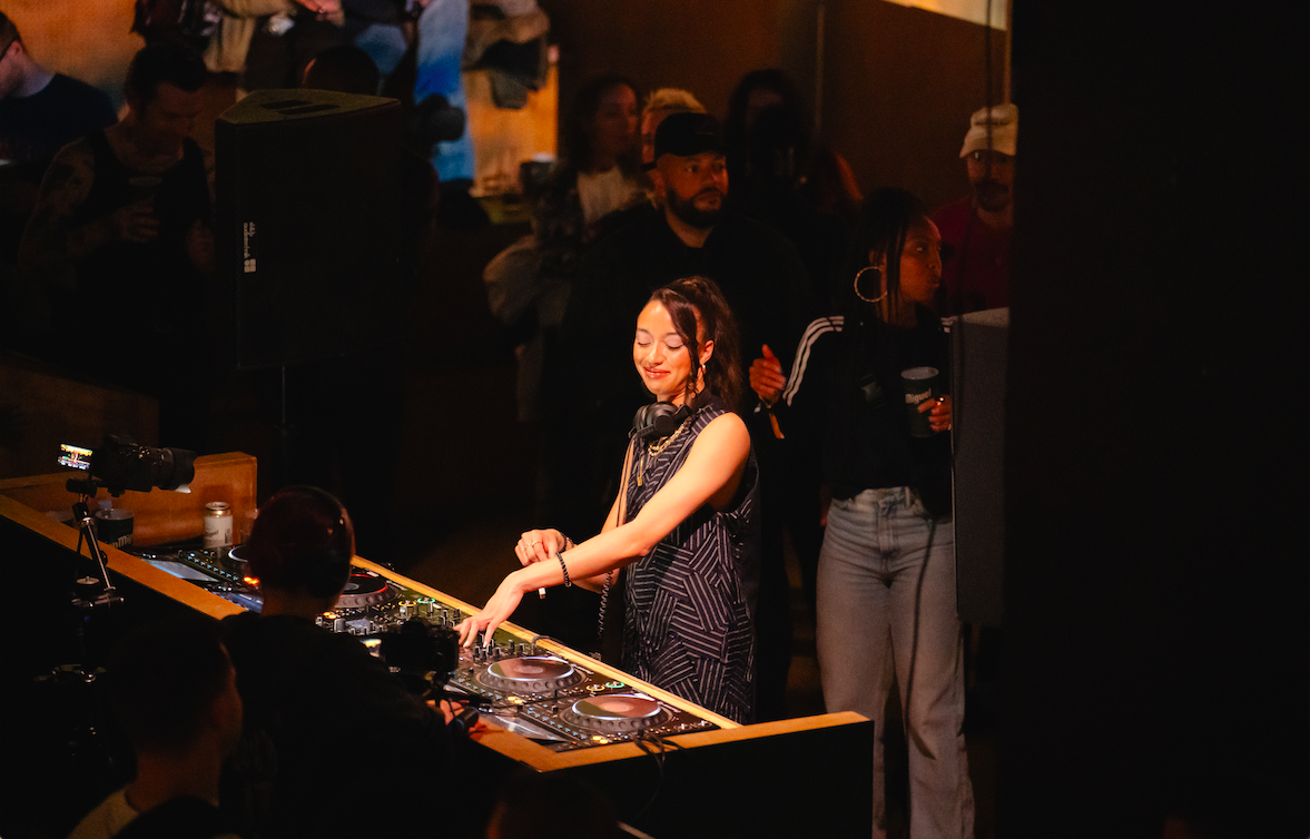 DJ energizing a diverse crowd at Christmas event in No90 Hackney Wick.